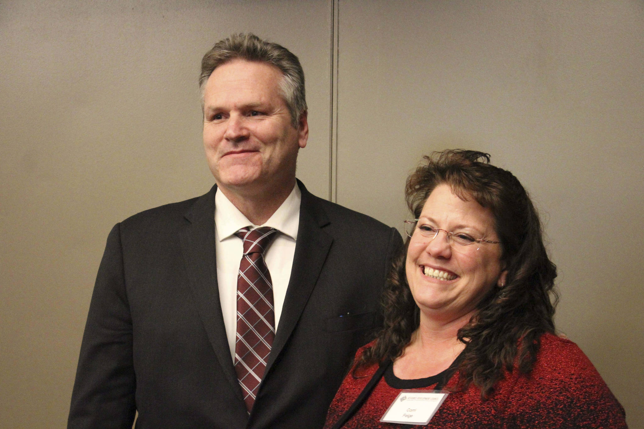 Alaska Gov.-elect Mike Dunleavy, left, poses with Corri Feige, whom Dunleavy named Wednesday, Nov. 14, 2018, during a speech in Anchorage, Alaska, as his commissioner of Natural Resources. Feige has spent her career working in the energy sector, including as a geophysicist and consultant and in management-level positions. (AP Photo/Mark Thiessen)
