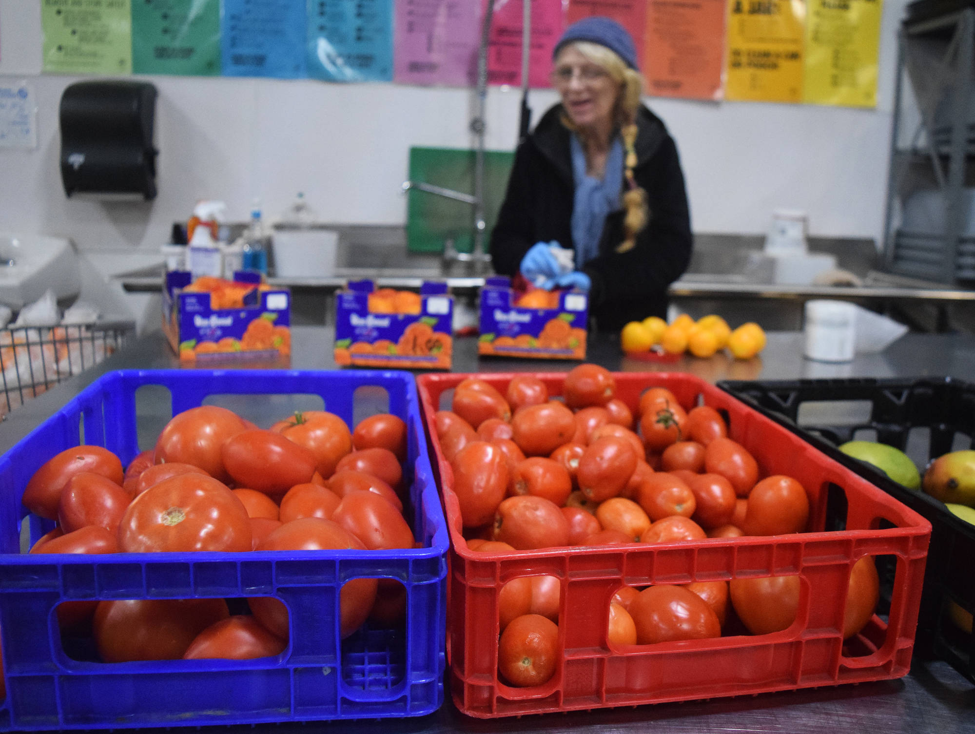Employee Kyle Wrate shows off tomatoes on Wednesday, Nov. 14 at the Kenai Peninsula Food Bank on K-Beach Road. The tomatoes will be used in this week’s Thanksgiving meal at the food bank. (Photo by Joey Klecka/Peninsula Clarion)