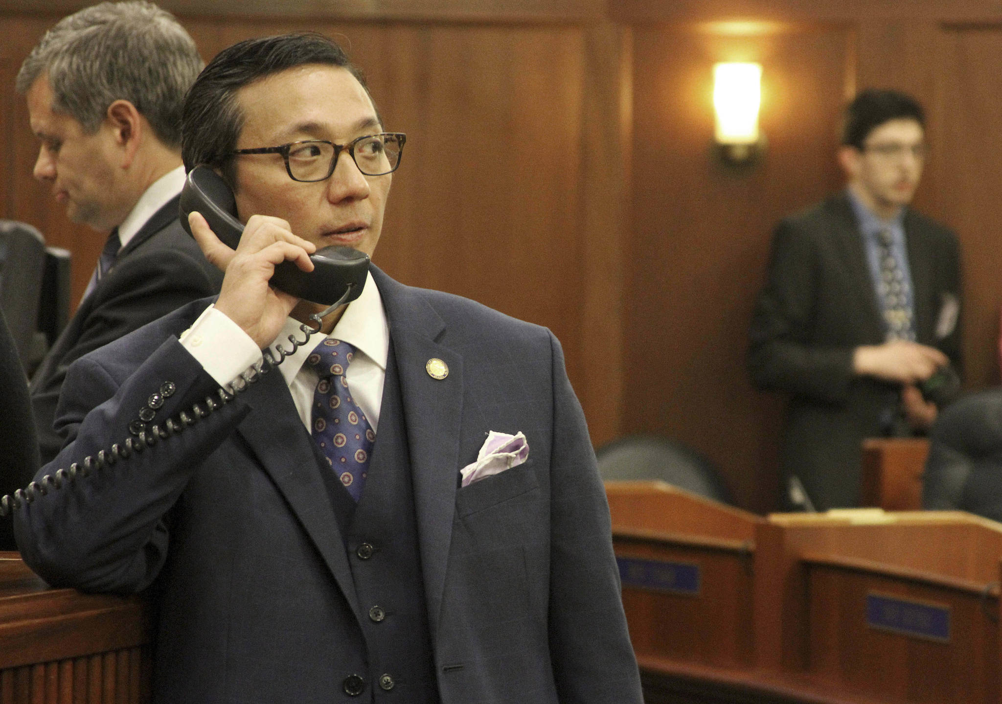 This Jan. 16 photo shows Alaska state Rep. Scott Kawasaki, a Fairbanks Democrat, talking on a telephone before the start of the legislative session at the state Capitol in Juneau. (AP Photo/Mark Thiessen, File)