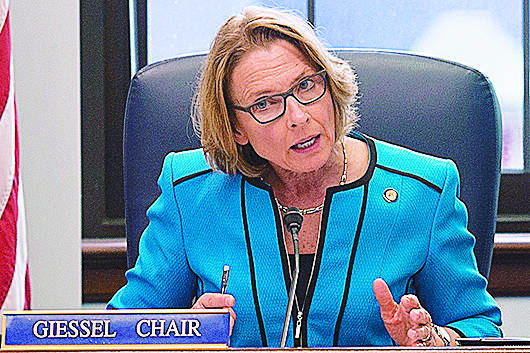 In this file photo, Sen. Cathy Giessel, R-Anchorage, reads one of the two versions of HB 111 dealing with oil tax credits during a Conference Committee hearing at the Capitol on Wednesday, July 12, 2017. (Michael Penn | Juneau Empire File)