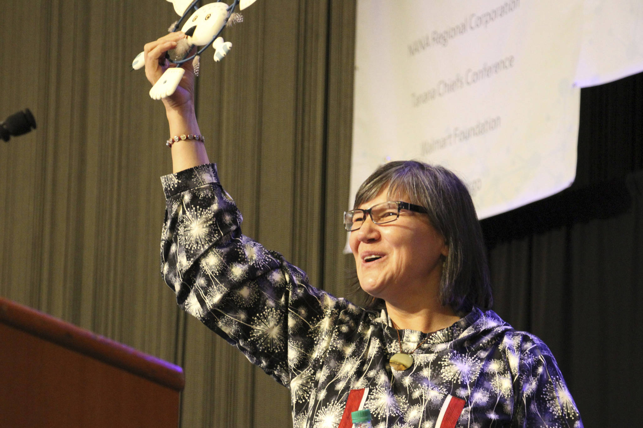 Alaska Lt. Gov. Valerie Davidson holds up an owl mask presented to her after addressing delegates at the annual Alaska Federation of Natives conference in Anchorage, Alaska, on Thursday, Oct. 18, 2018. Davidson was sworn in as lieutenant governor on Oct. 16, 2018, after Bryon Mallott resigned. (AP Photo/Mark Thiessen)