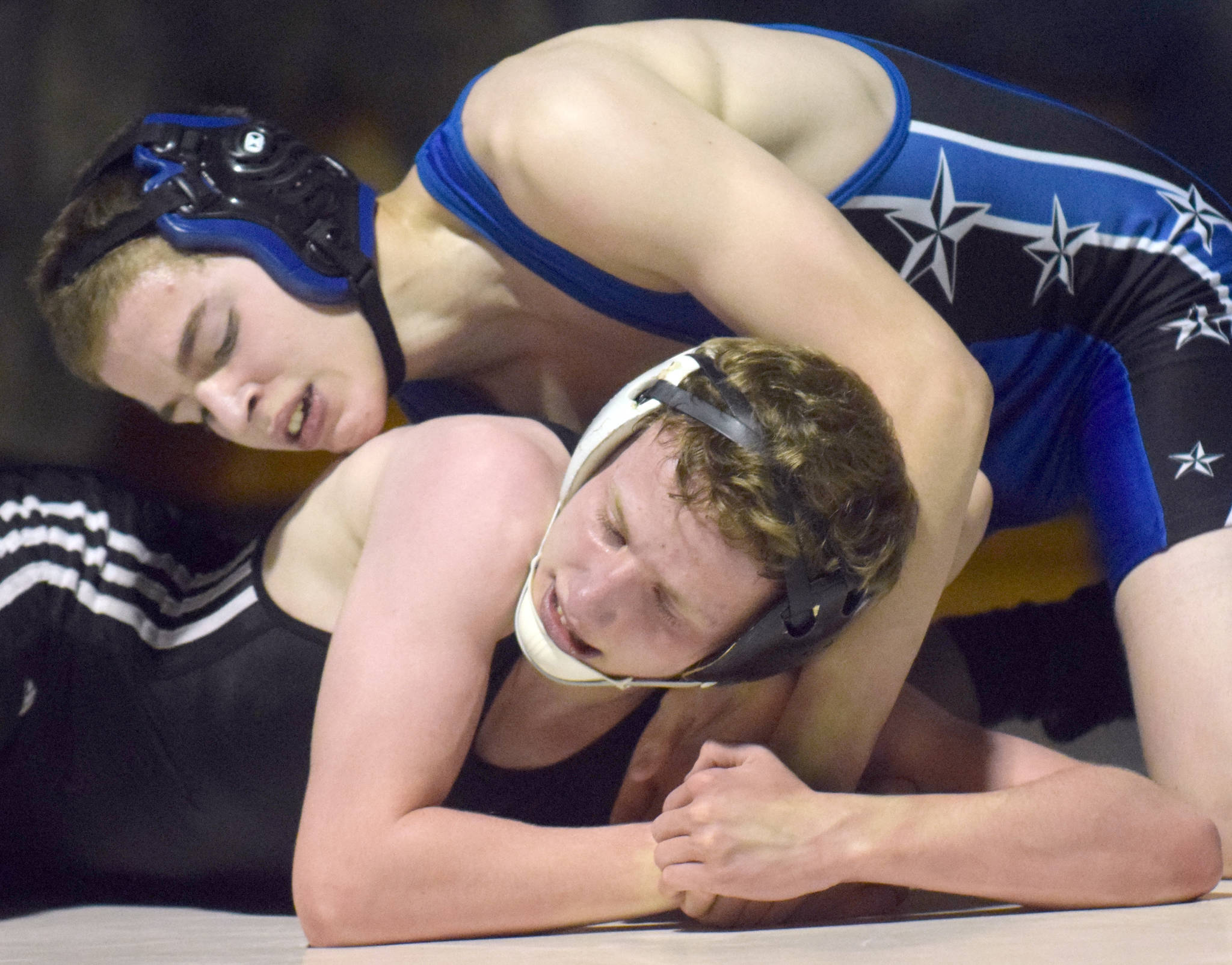 Soldotna’s Saiyan Baker controls Nikiski’s Chase Olsen on Tuesday, Nov. 20, 2018, at Nikiski High School. Olsen scored a 10-2 major decision. (Photo by Jeff Helminiak/Peninsula Clarion)