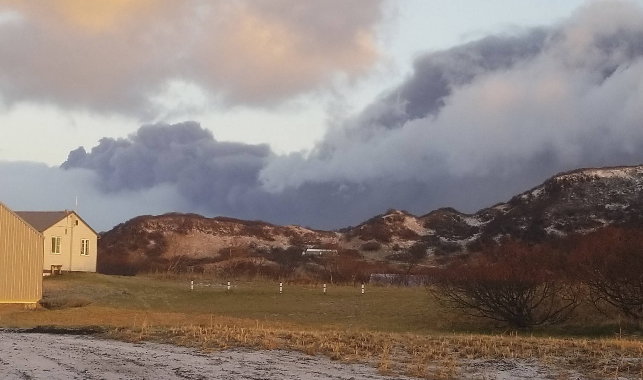 A black ash cloud from Alaska’s Mount Veniaminof passes the community of Perryville, Alaska, on Wednesday, Nov. 21, 2018. Alaska Volcano Observatory scientists said the overnight ash emissions from Mount Veniaminof generated an ash plume that drifted more than 150 miles to the southeast. (Victoria Tague via AP)