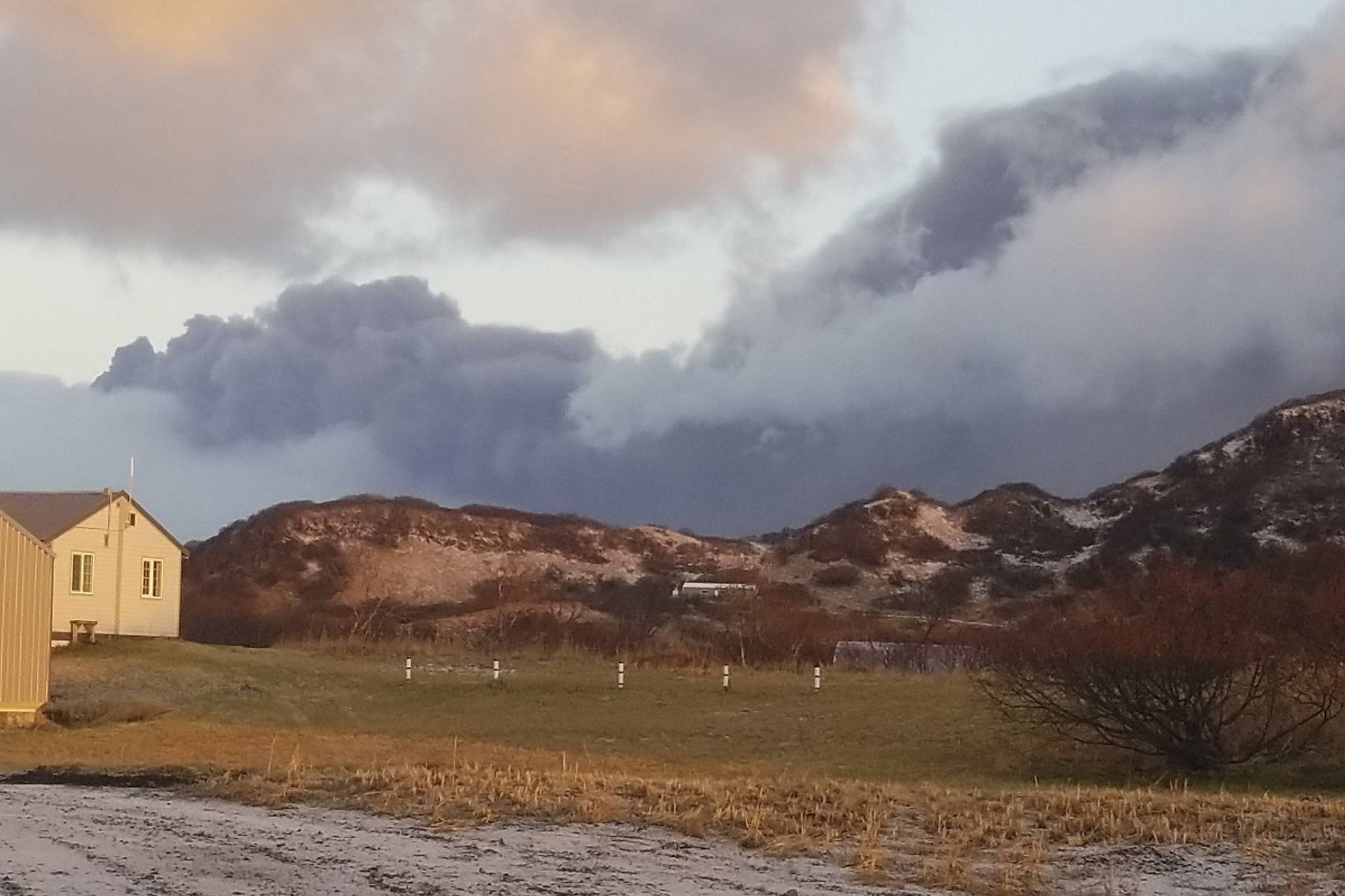 A black ash cloud from Alaska’s Mount Veniaminof passes the community of Perryville, Alaska, on Wednesday, Nov. 21, 2018. Alaska Volcano Observatory scientists said the overnight ash emissions from Mount Veniaminof generated an ash plume that drifted more than 150 miles (241 kilometers) to the southeast. (Victoria Tague via AP)