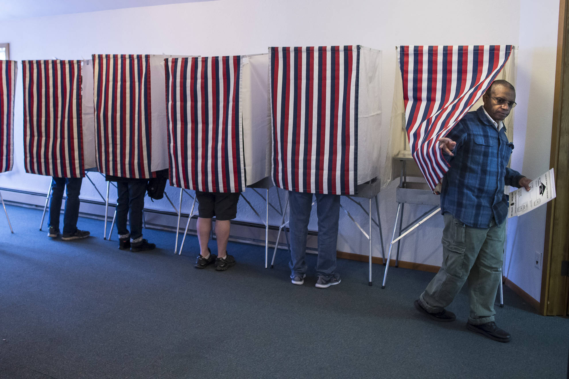 Hector Mojica exits a voting booth at Glacier Valley Baptist Church on Election Day, Tuesday, Nov. 6, 2018. (Michael Penn | Juneau Empire)