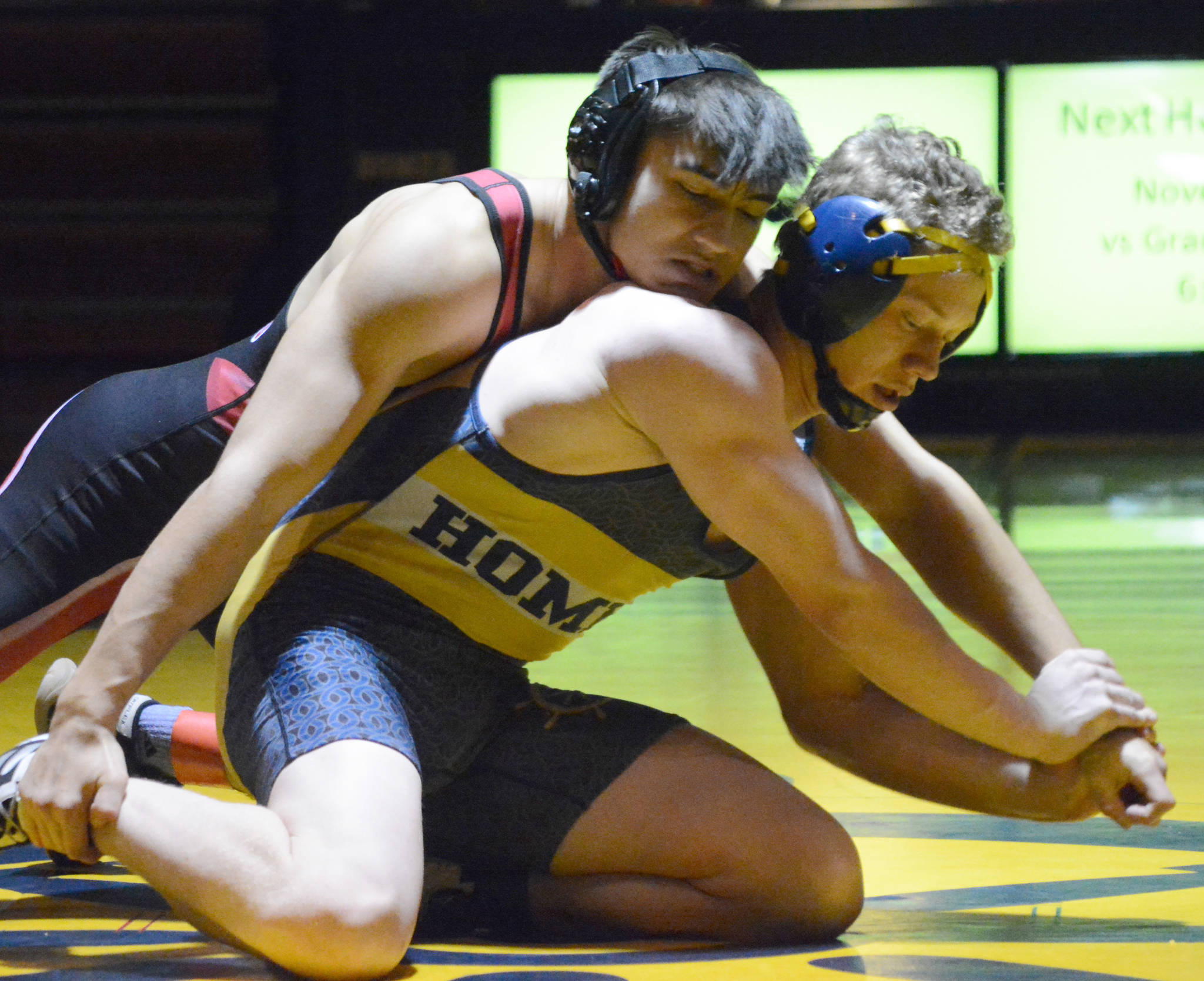 Homer’s Mose Hayes, right, wrestles with Kenai Central’s Brandon Kroto, left, in a meet held Wednesday, Nov. 21, 2018, at the Homer High Schol Alice Witte Gym in Homer, Alaska. (Photo by Michael Armstrong/Homer News)