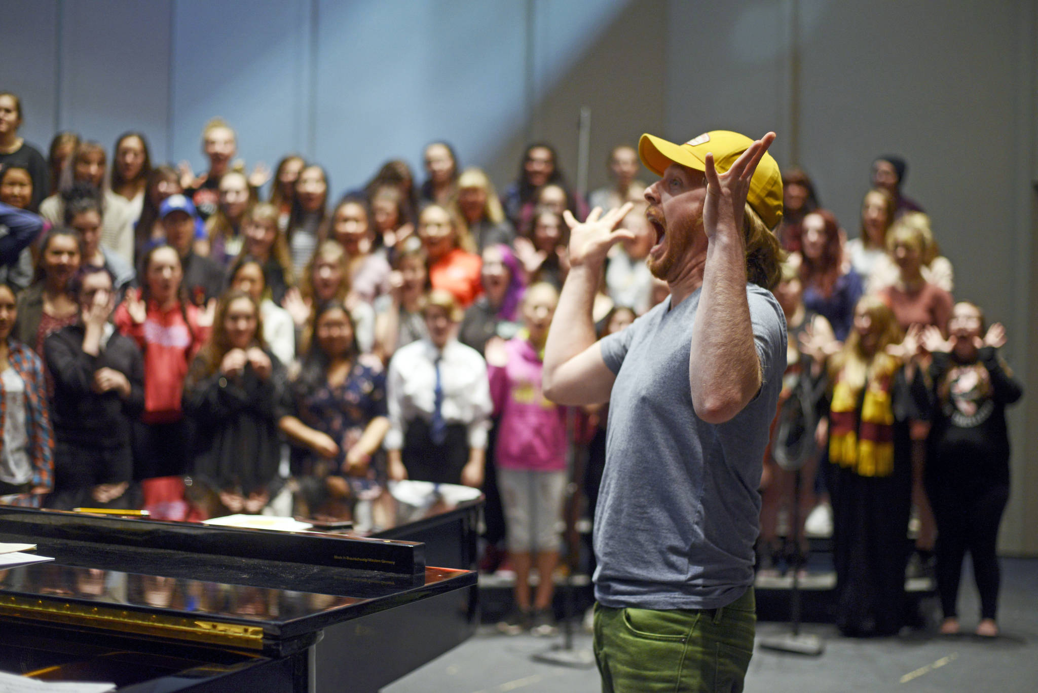 Simon Nissen leads a section of his choir class in vocal warm-ups in preparation for the holiday concert on December 15, 2017 at Kenai Central High School in Kenai, Alaska. (Photo by Kat Sorensen/Peninsula Clarion)