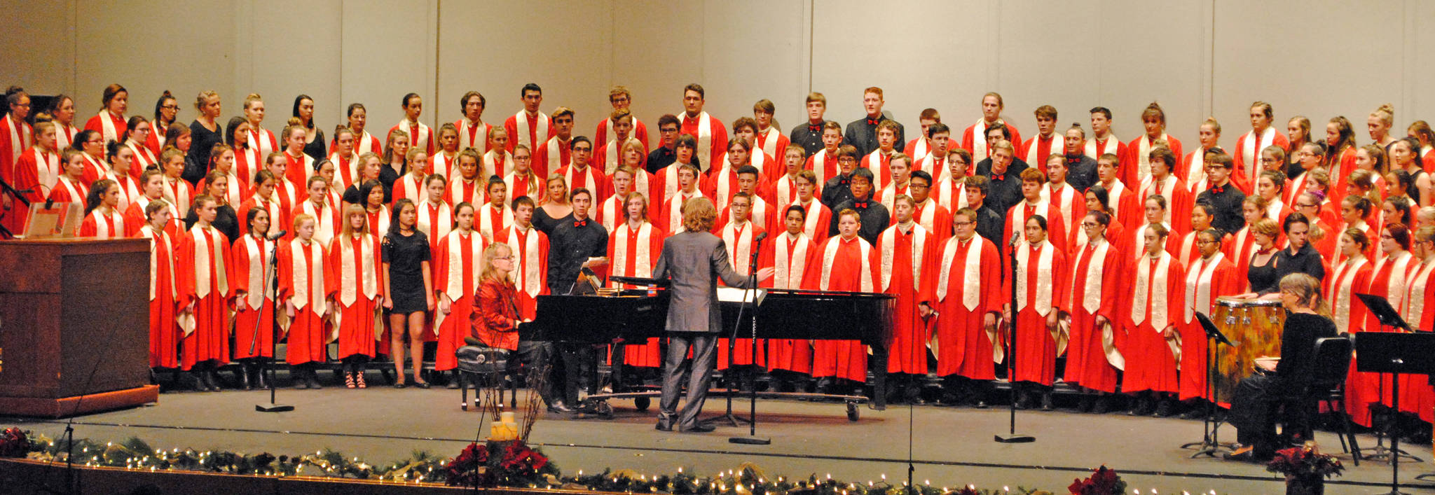 Kenai Central High School choir teacher Simon Nissen leads the school’s choir during their annual holiday concert on Dec. 17 in Kenai Central High School’s Renee C. Henderson Auditorium. Students dressed in black were recognized this year as member’s of Alaska’s All-State Choir. Kenai Central had 23 students honored by the program, the most out of any school in the state, according to Nissen. (Photo by Kat Sorensen/Peninsula Clarion)