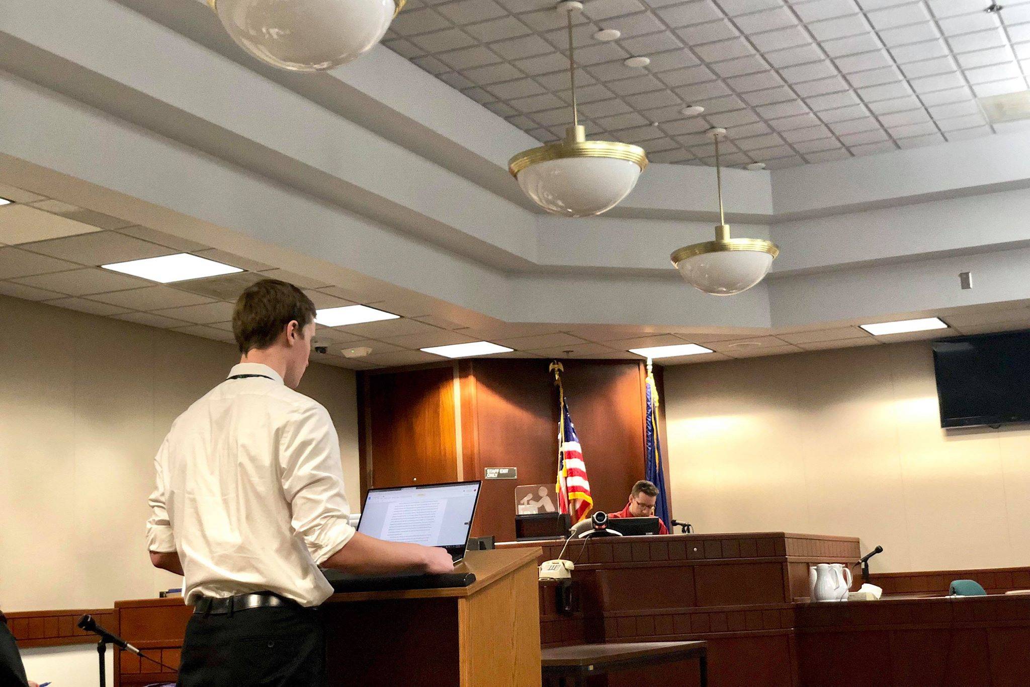 Mock prosecutor Gabriel Smith gives his counsel’s introductory remarks to attorney Paul Morin, who acted as judge during Nikiski High’s mock murder trial at the Kenai Courthouse on Thursday. (Photo by Victoria Petersen/Peninsula Clarion)