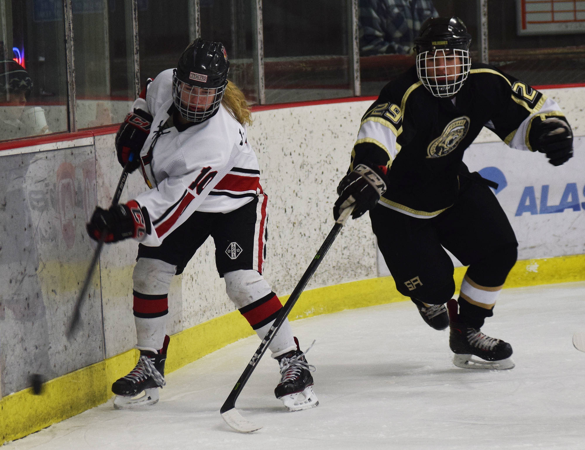 Kenai’s Jordyn Stock keeps the puck away from South skater Josh Costello (left) Thursday night against South at the Kenai Multi-Purpose Facility. (Photo by Joey Klecka/Peninsula Clarion)