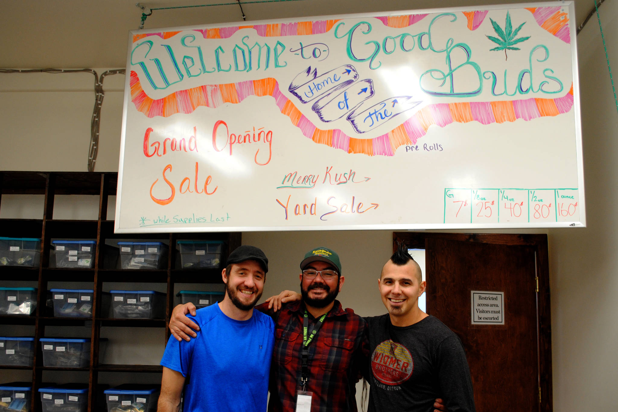 Good Buds store manager Brandon Mason, from left, and owners Charles Spalding and Jared Wallace mark the grand opening of the first retail cannabis store on the eastern Kenai Peninsula. Tekoa Wallace of Hawaii is also a part owner of the business. (Photo by Kat Sorensen/Peninsula Clarion)