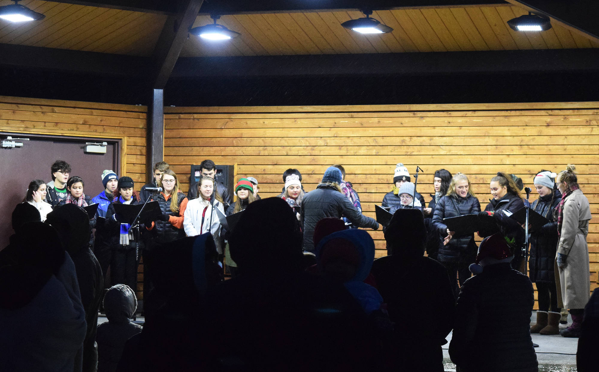 Members of the Kenai Central High School choir treat guests to holiday music Saturday, Dec. 1 at the Christmas in the Park tree-lighting ceremony at Soldotna Creek Park, in Soldotna, Alaska.. (Photo by Joey Klecka/Peninsula Clarion)