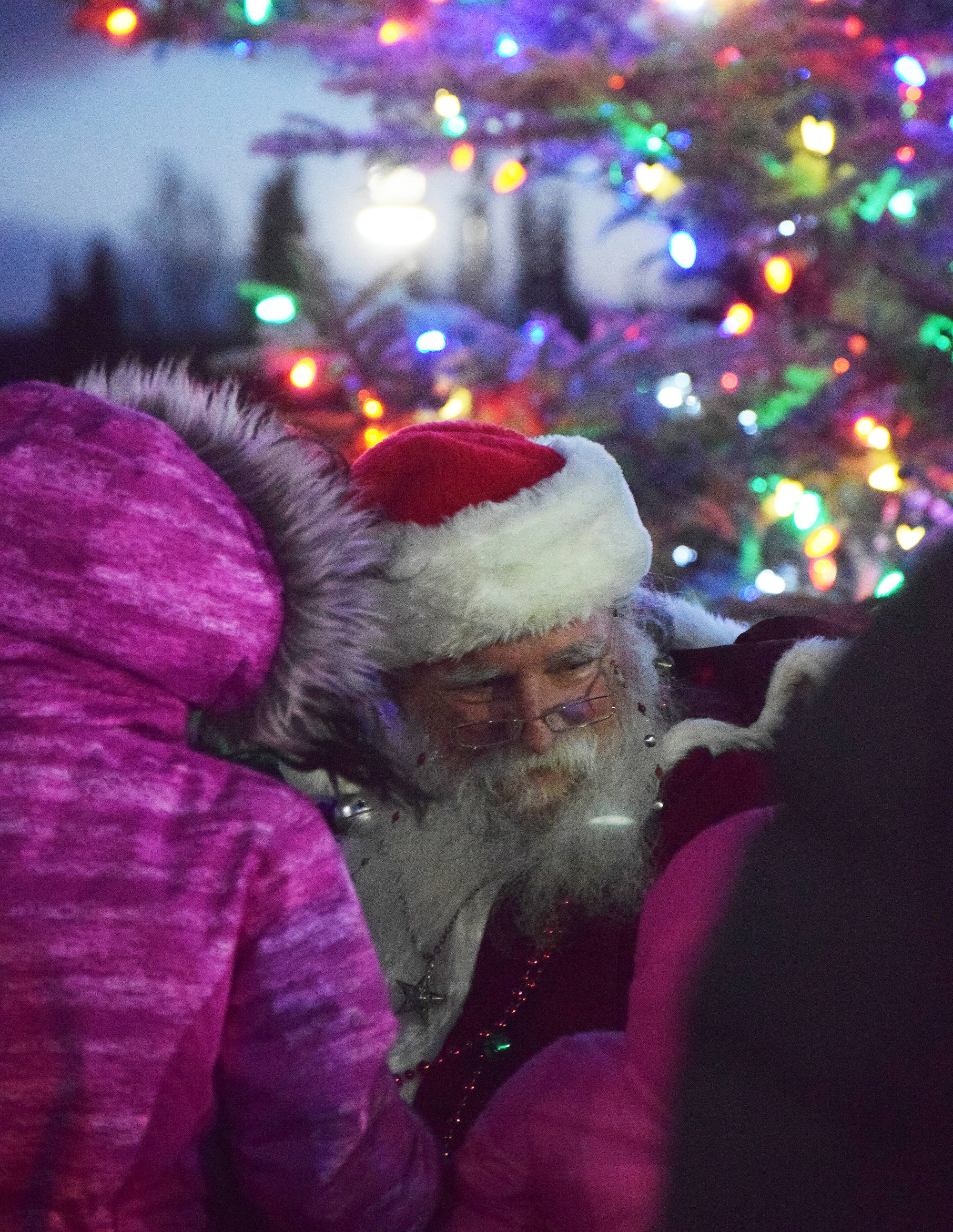 Santa Claus listens to requests from children Saturday, Dec. 1 at the Christmas in the Park tree-lighting ceremony at Soldotna Creek Park, in Soldotna, Alaska. (Photo by Joey Klecka/Peninsula Clarion)
