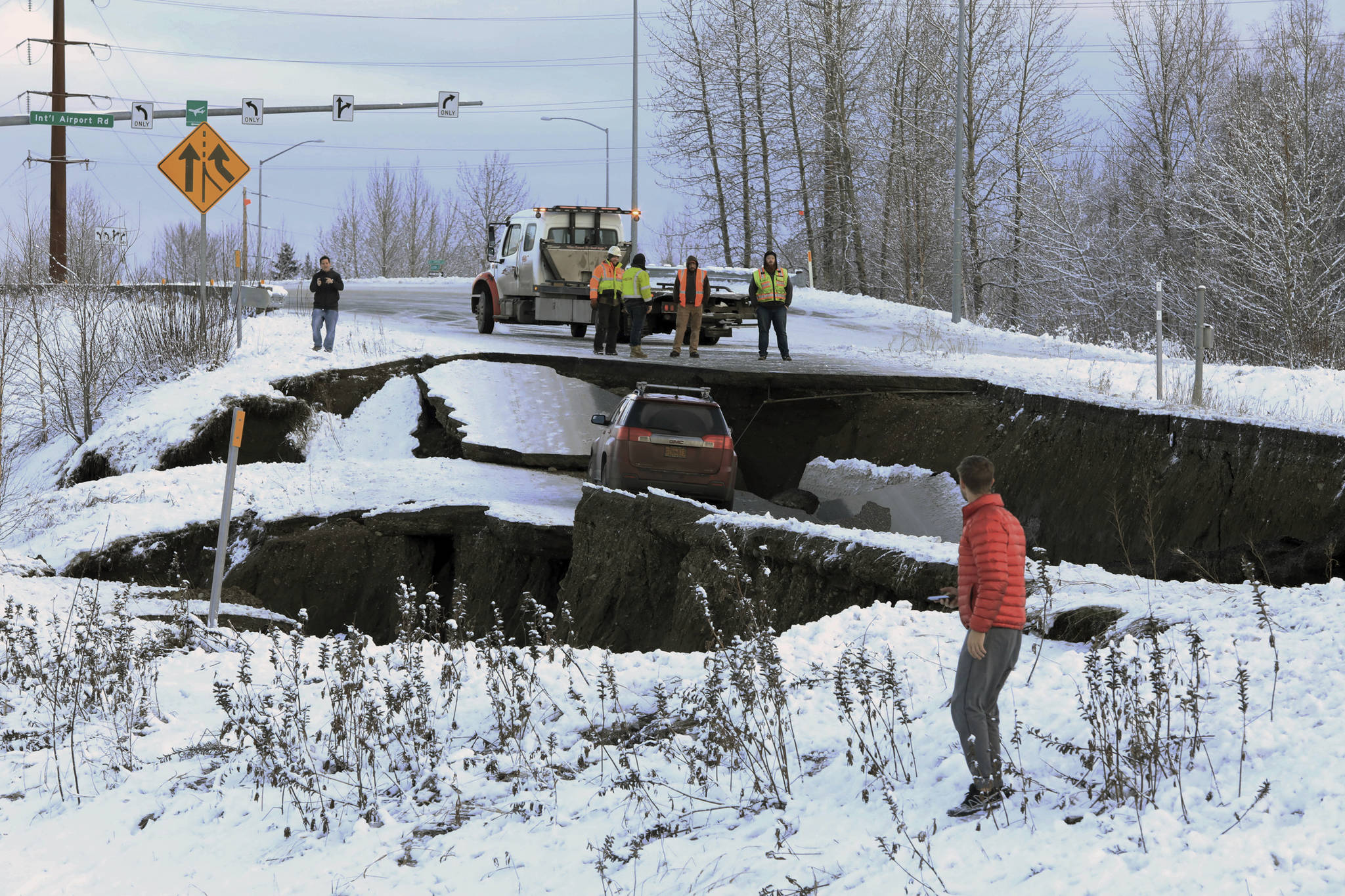 A car belonging to Homer resident Tom Sulczynski is trapped on a collapsed section of the offramp of Minnesota Drive in Anchorage, Friday, Nov. 30, 2018. Sulczynski and passenger Bekah Taylor escaped the car without injury. Back-to-back earthquakes measuring 7.0 and 5.8 rocked buildings and buckled roads Friday morning in Anchorage, prompting people to run from their offices or seek shelter under office desks, while a tsunami warning had some seeking higher ground. (AP Photo/Dan Joling)