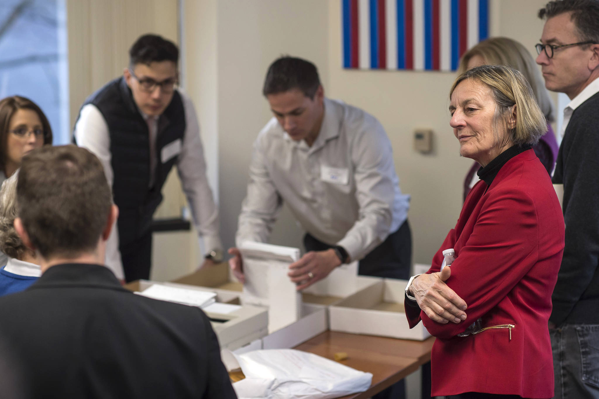 Alaska House District 1 candidate Democrat Kathryn Dodge, right, watches the election recount at the Department of Elections’ Juneau office on Friday, Nov. 30, 2018. A single mystery ballot found on a precinct table on Election Day but not counted then could decide a tied Alaska state House race and thwart Republican efforts to control the chamber and all of state government. The ballot arrived in Juneau last Friday in a secrecy sleeve in a bin with other ballot materials. Officials were investigating its origins and handling before deciding whether to tally it. (Michael Penn/The Juneau Empire via AP)