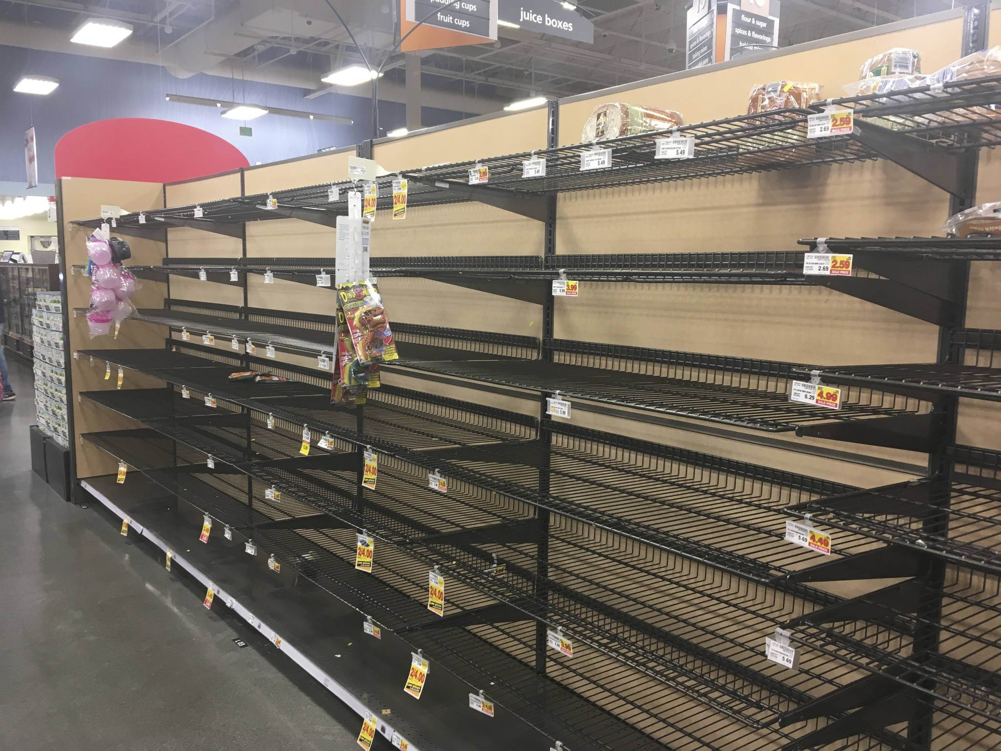 Empty shelves where bread is normally located are shown at a grocery store in Anchorage on Sunday, two days after a magnitude 7.0 earthquake was centered about 7 miles north of the city. Anchorage officials urged residents not to stock up and hoard supplies because the supply chain of goods was not interrupted. (AP Photo/Mark Thiessen)