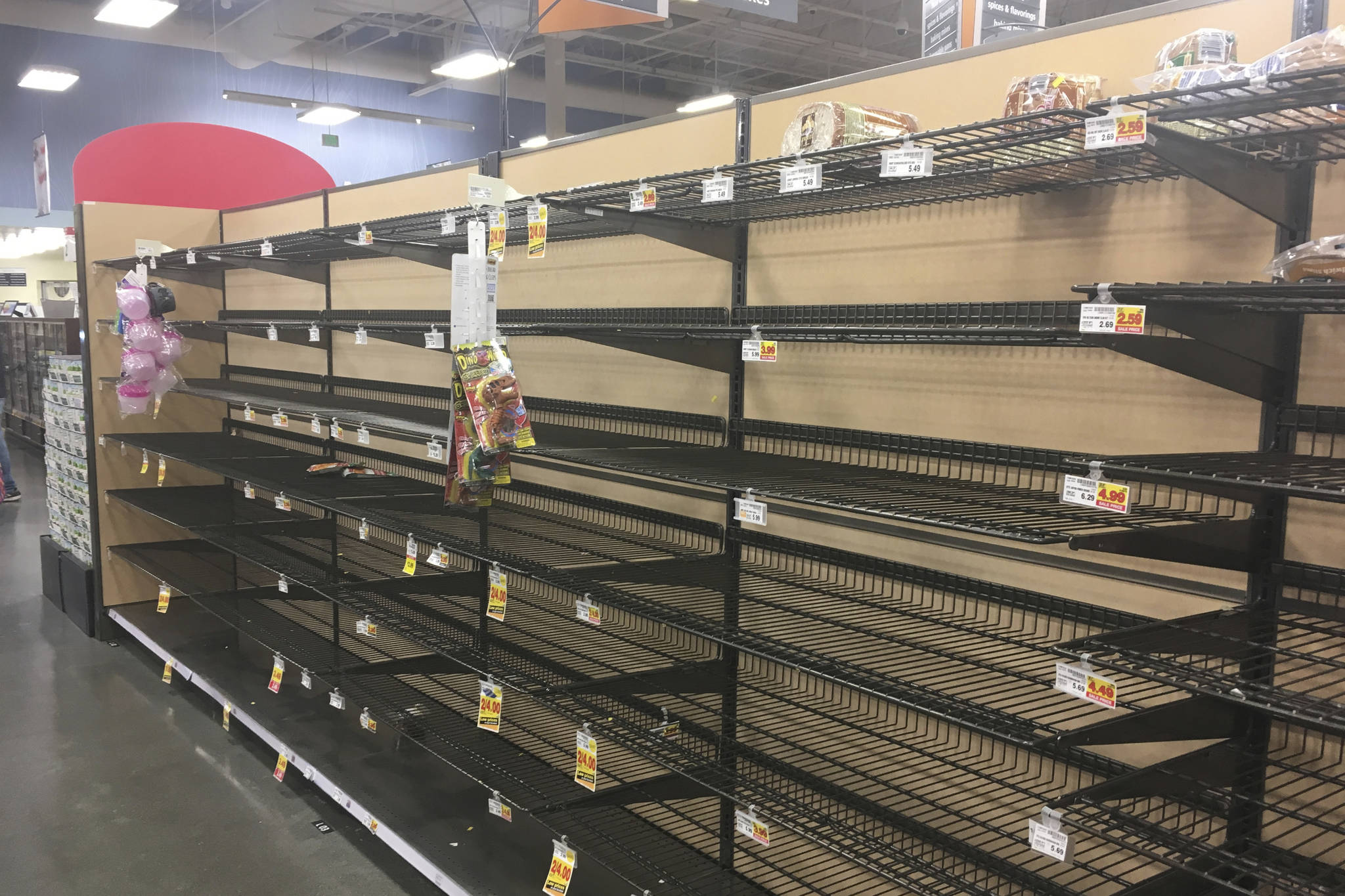Empty shelves where bread is normally located are shown at a grocery store in Anchorage, Alaska, on Sunday, Dec. 2, 2018, two days after a magnitude 7.0 earthquake was centered about 7 miles north of the city. Anchorage officials urged residents not to stock up and hoard supplies because the supply chain of goods was not interrupted. (AP Photo/Mark Thiessen)