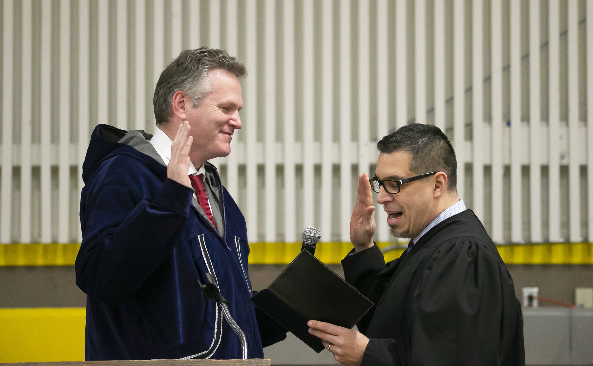 Mike Dunleavy, left, is sworn into office as Alaska’s governor by Superior Court Judge Paul Roetman in Kotzebue, Alaska, on Monday. Poor visibility forced Dunleavey’s swearing-in ceremony to be held in Kotzebue instead of Noorvik, Alaska, his wife’s hometown. (Stanley Wright/Alaska Governor’s Office via AP)