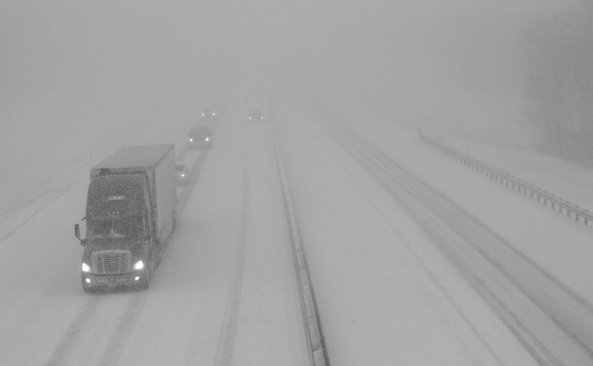 Traffic moves west along I-70 near Lawrence, Kan., Sunday, Nov. 25, 2018. I-70 is closed west of Junction City, Kan. (AP Photo/Orlin Wagner)