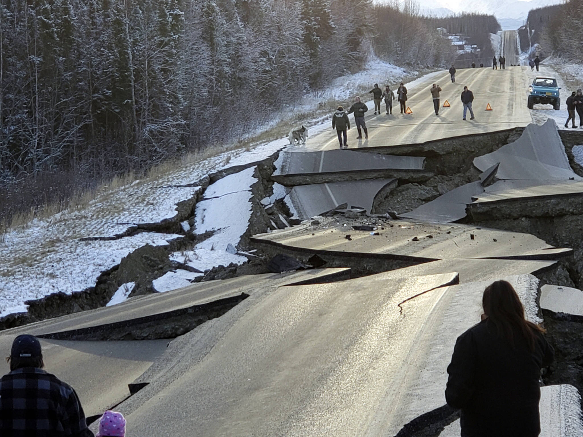 In this Nov. 30 file photo, provided by Jonathan M. Lettow, people walk along Vine Road after an earthquake in Wasilla, Alaska. Alaska State Troopers are asking that people do not take selfies in front of the buckled roadway north of Anchorage, Alaska. (Jonathan M. Lettow via AP, File)