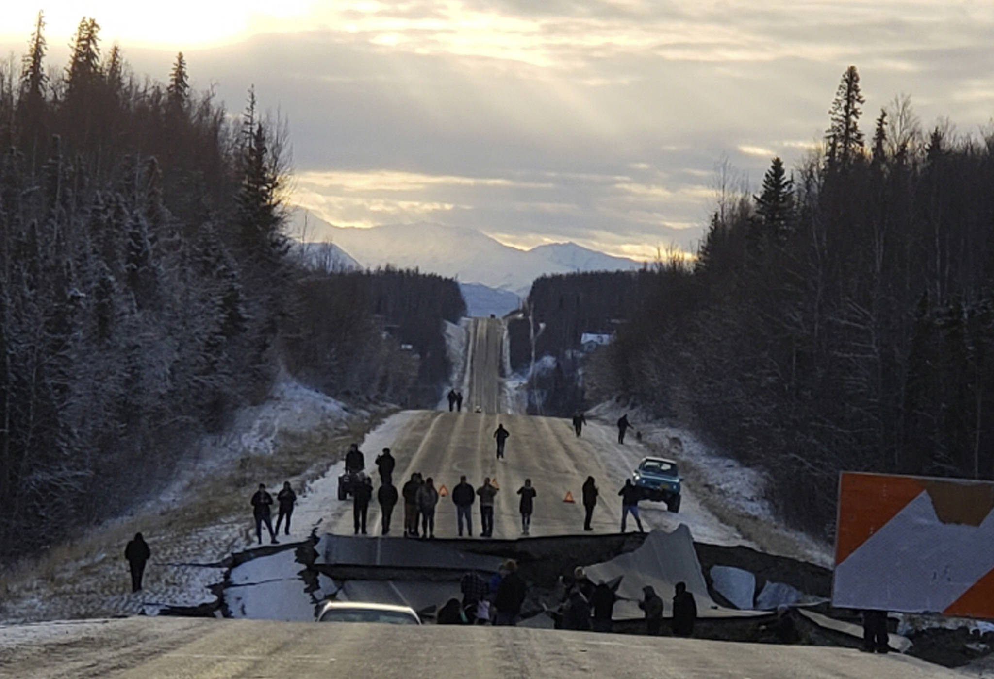 In this Nov. 30, 2018 file photo, provided by Jonathan M. Lettow, people walk along Vine Road after an earthquake in Wasilla, Alaska. Alaska State Troopers are asking that people do not take selfies in front of the buckled roadway north of Anchorage, Alaska. (Jonathan M. Lettow via AP, File)