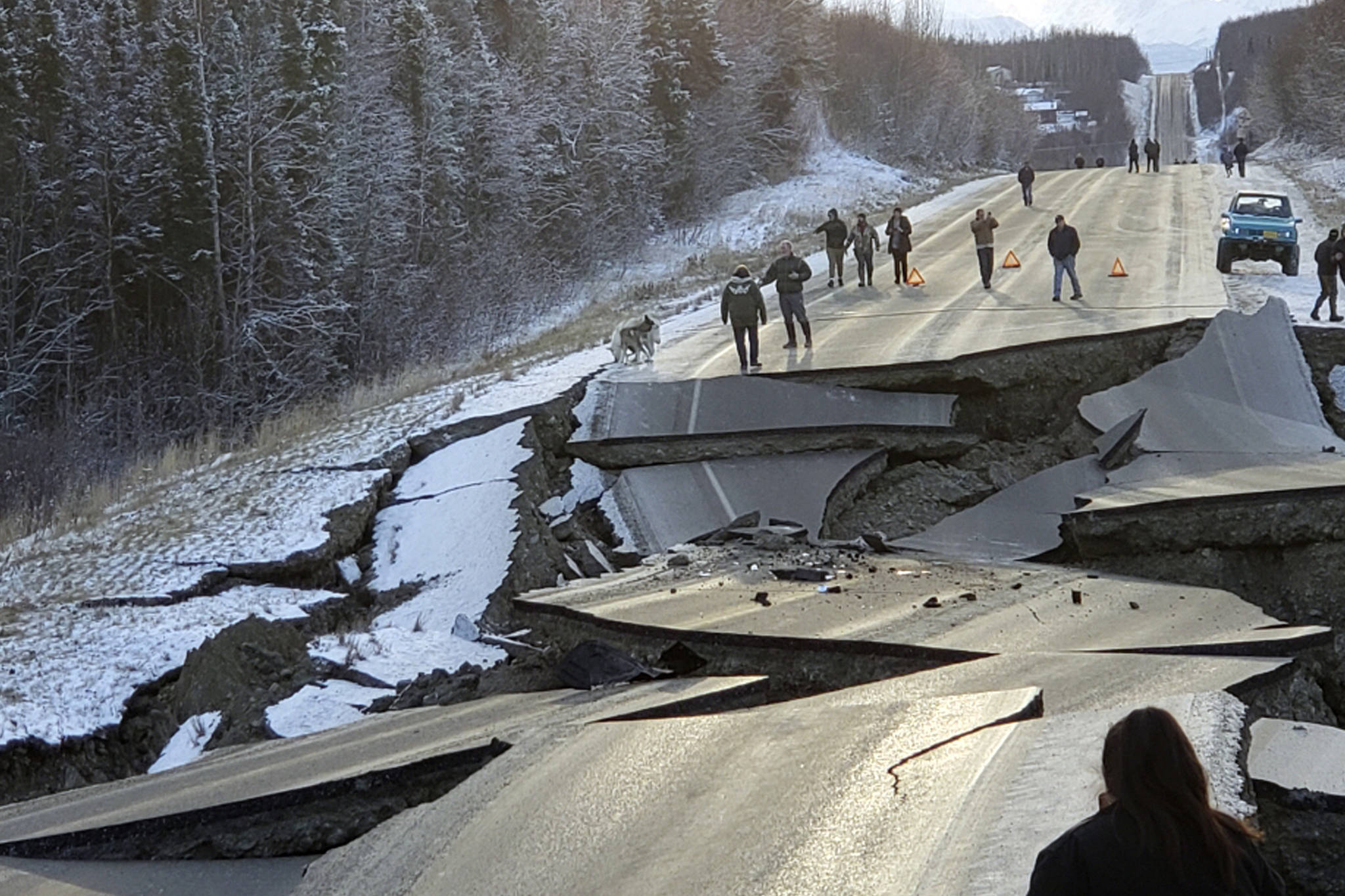 In this Nov. 30, 2018 file photo, provided by Jonathan M. Lettow, people walk along Vine Road after an earthquake in Wasilla, Alaska. Alaska State Troopers are asking that people do not take selfies in front of the buckled roadway north of Anchorage, Alaska. (Jonathan M. Lettow via AP, File)