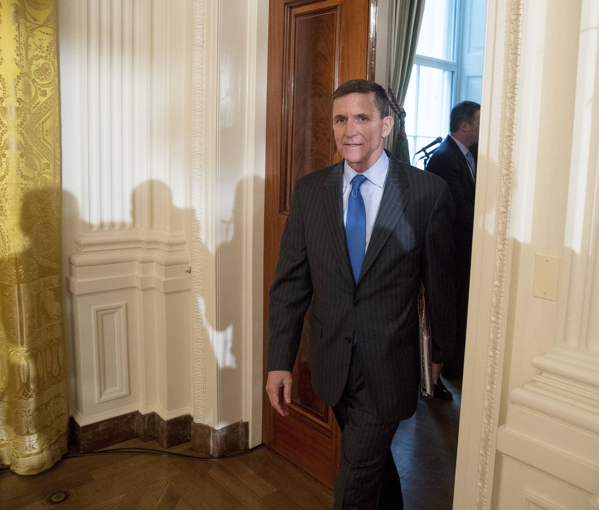 In this Jan. 22, 2017 file photo, National Security Adviser Michael Flynn arrives for a White House senior staff swearing in ceremony in the East Room of the White House, in Washington. President Donald Trump’s former national security adviser has provided so much information to the special counsel’s Russia investigation that prosecutors say he shouldn’t do any prison time, according to a court filing Tuesday, Dec. 4, 2018, that describes Flynn’s cooperation as “substantial.” (AP Photo/Andrew Harnik, File)