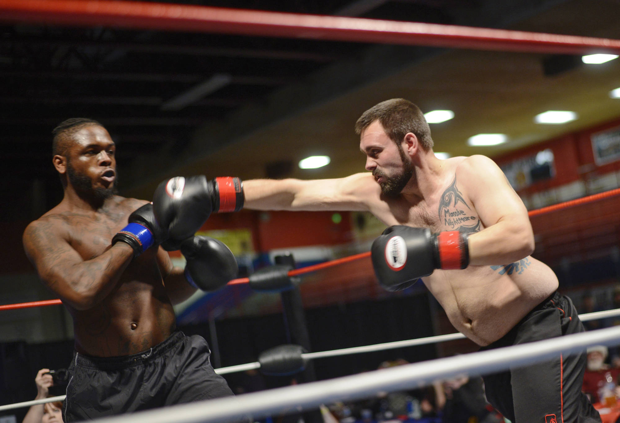 Melvin Clark, Jr., (left) evades a swing from fellow Nikiski fighter Doug McFresh in a boxing match Saturday night at the Fight Before Christmas 2 at the Soldotna Regional Sports Complex. (Photo by Ben Boettger/Peninsula Clarion)