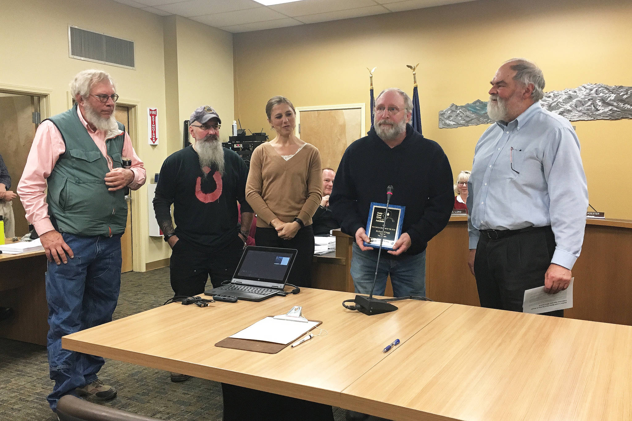 From left to right: Public Works Director Carey Meyer, Water and Sewer Superintendent Todd Cook, City Manager Katie Koester, Richard Klopp, lead water distribution and wastewater collection operator, and Mayor Ken Castner celebrate Klopp being named Wastewater Operator of the Year award by the Alaska Rural Water Association during the Monday, Nov. 26, 2018 Homer City Council meeting at Homer City Hall in Homer, Alaska. (Photo by Megan Pacer/Homer News)