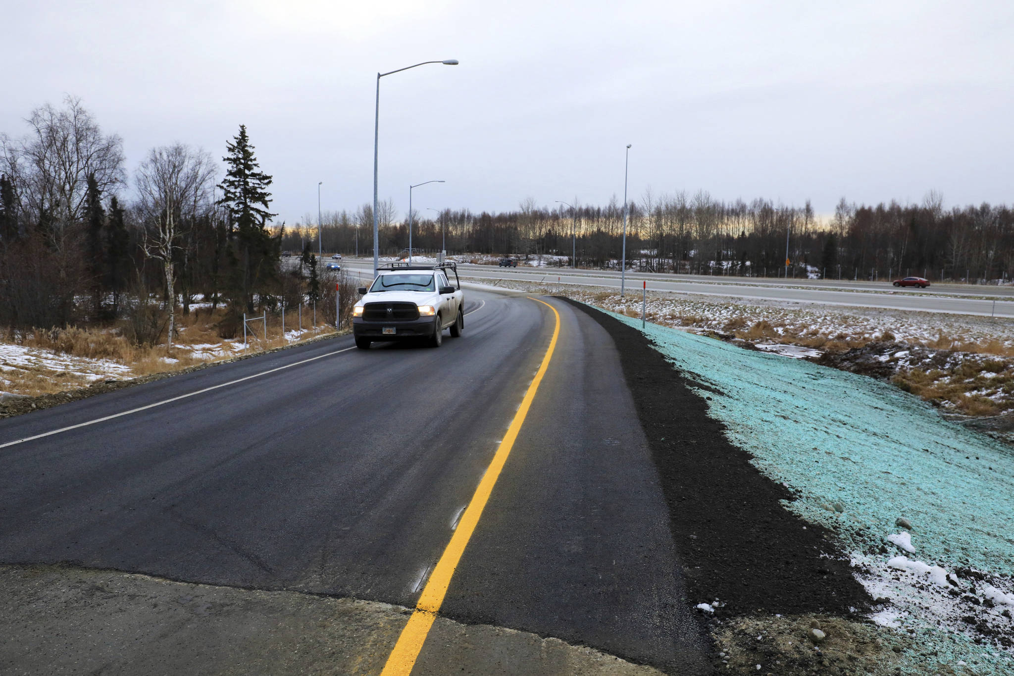 A pickup truck drives up a newly repaired off-ramp of Minnesota Drive on Wednesday, Dec. 5, 2018, in Anchorage, Alaska. A massive 7.0 earthquake and its aftershocks rocked buildings and buckled roads Nov. 30, including the ramp that’s a route to Ted Stevens Anchorage International Airport. Alaska transportation officials made rebuilding the ramp a priority. It reopened Tuesday, Dec. 4, and a crew completed shoulder work Wednesday. (AP Photo/Dan Joling)