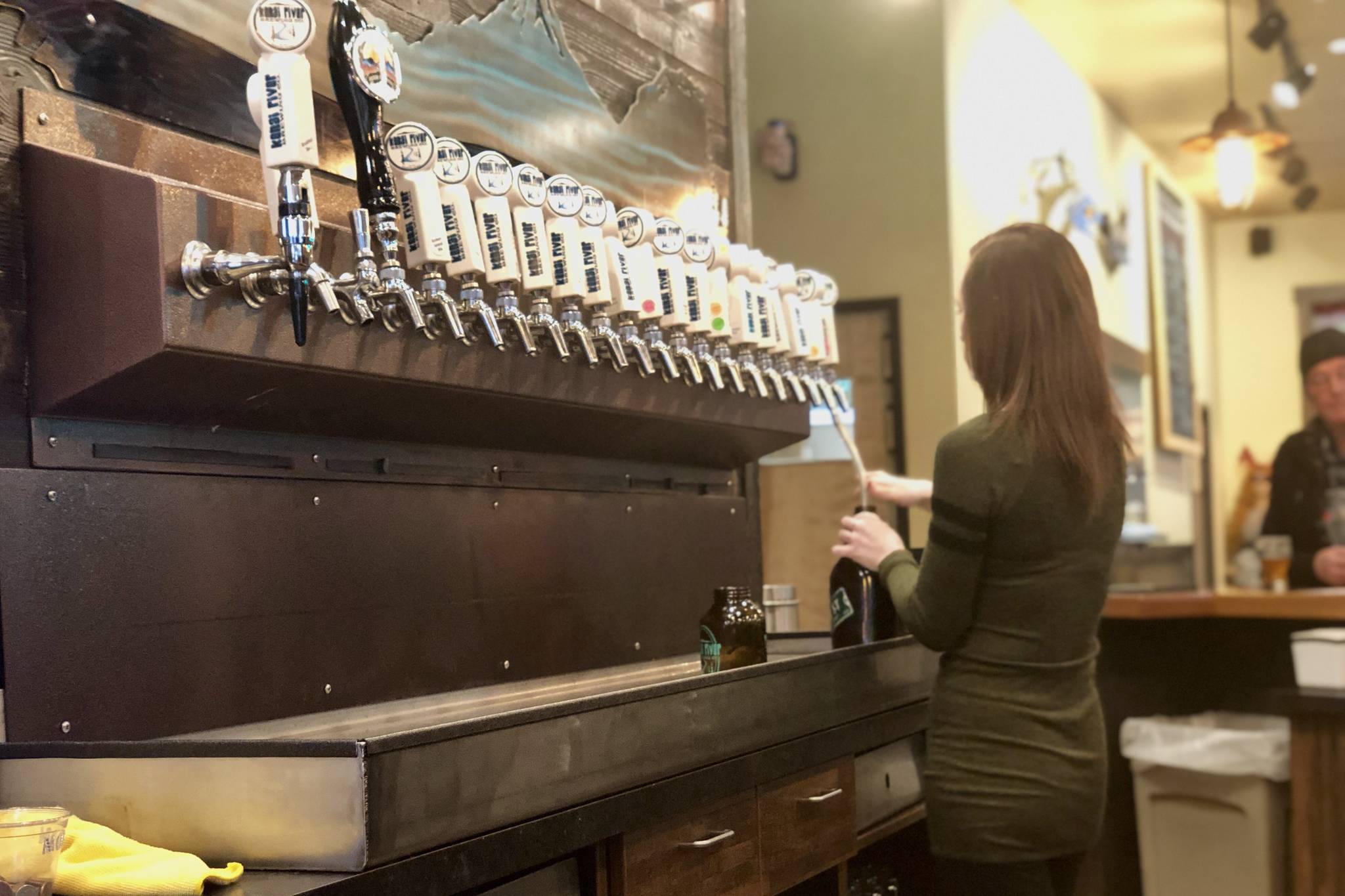 A bartender pours a beer at Kenai River Brewing Company on Saturday in Soldotna. Kenai River is serving a chocolate pumpkin porter beer as part of their seasonal offerings, (Photo by Victoria Petersen/Peninsula Clarion)