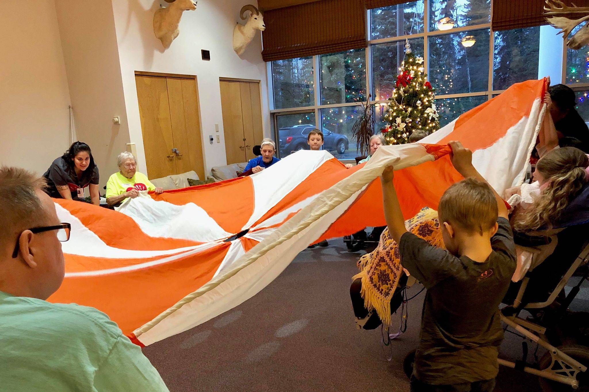Kindergartners from K-Beach Elementary play games with residents from Heritage Place during a Dignity Mission activity on Friday, Dec. 7, 2018, in Soldotna, Alaska. (Photo by Victoria Petersen/Peninsula Clarion)