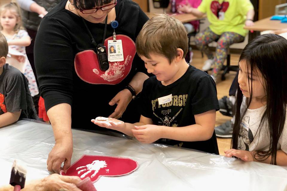 Residents from Heritage Place help kindergartner students make Dignity Mission T-shirts during a visit on Friday, Dec. 7, 2018, in Soldotna, Alaska. (Photo by Victoria Petersen/Peninsula Clarion)