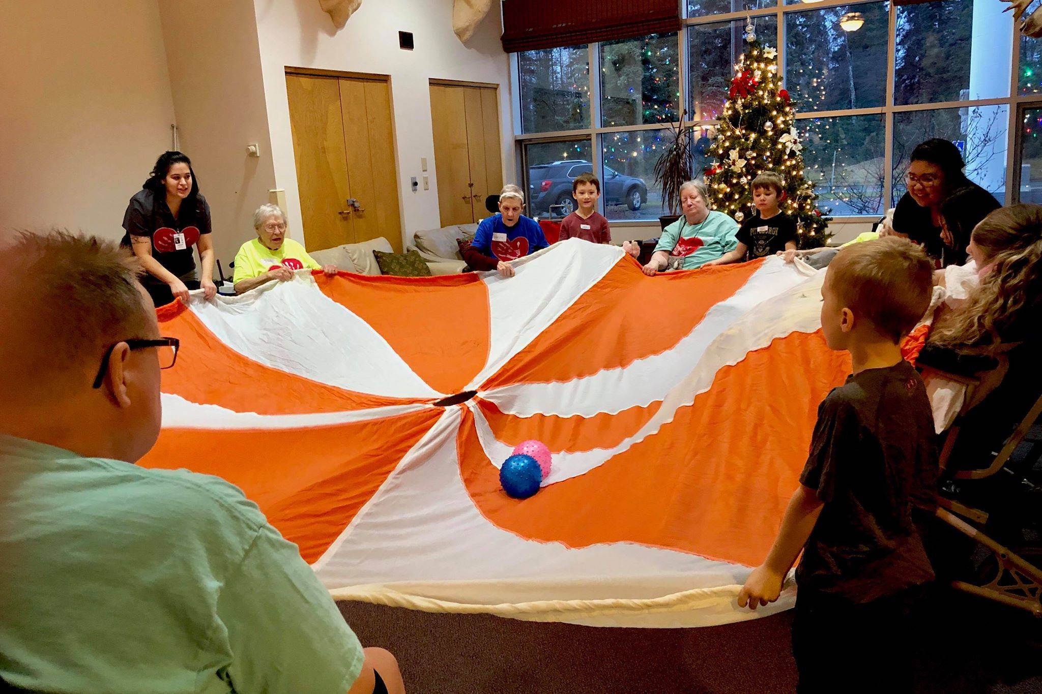 Kindergartners from K-Beach Elementary play games with residents from Heritage Place during a Dignity Mission activity on Friday, Dec. 7, 2018, in Soldotna, Alaska. (Photo by Victoria Petersen/Peninsula Clarion)