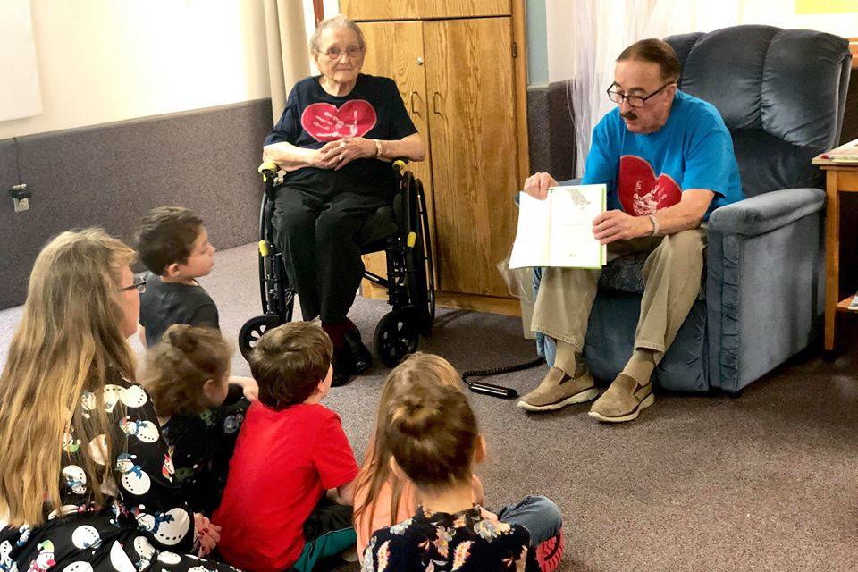 During Friday’s Dignity Mission, residents of Heritage Place read to kindergartners from K-Beach Elementary, on Dec. 7, 2018, in Soldotna, Alaska. (Photo by Victoria Petersen)