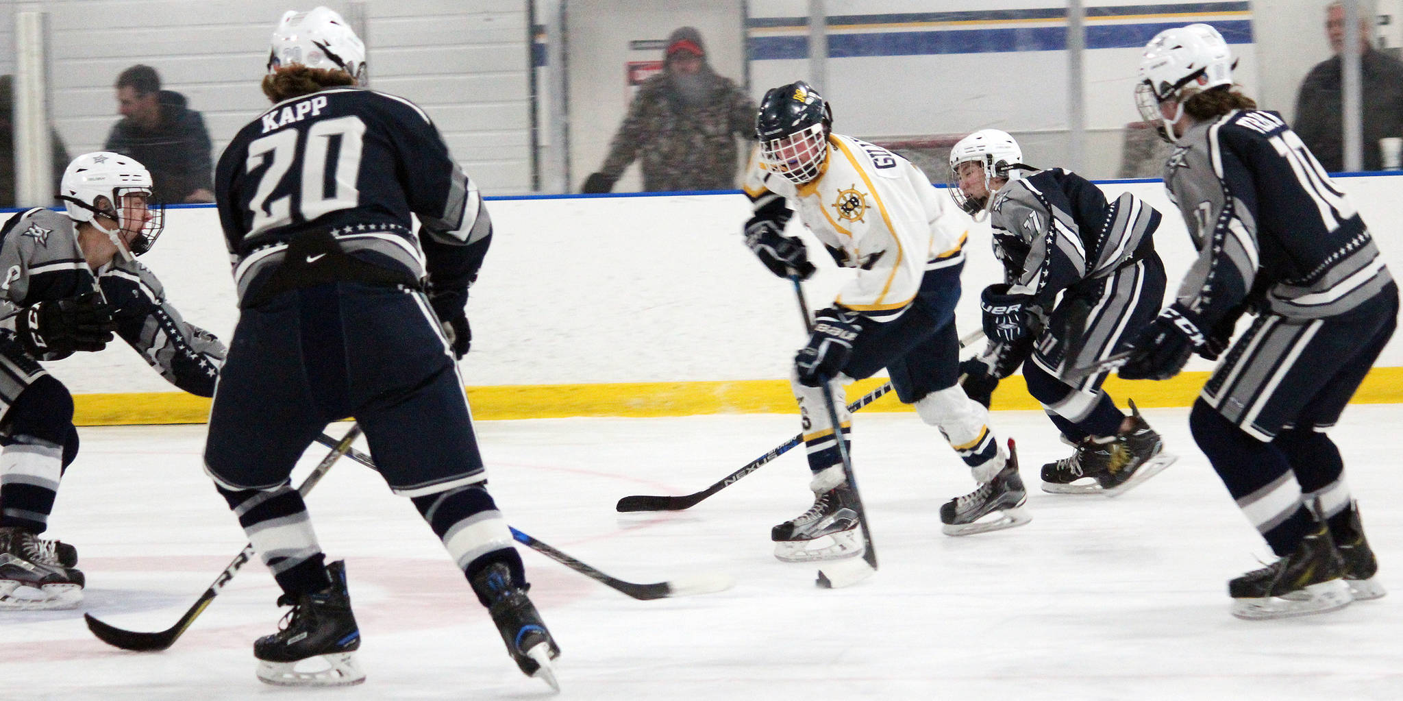 Homer’s Tyler Gilliland controls the puck while four Soldotna High School skaters close in on him during a Friday, Dec. 7, 2018, game at the Kevin Bell Arena in Homer, Alaska. The game, which the Stars won 4-0, was a fundraiser to raise money for the Big Lake Rec Center in the Mat-Su Valley, which was damaged by the Nov. 30 earthquake. (Photo by Megan Pacer/Homer News)