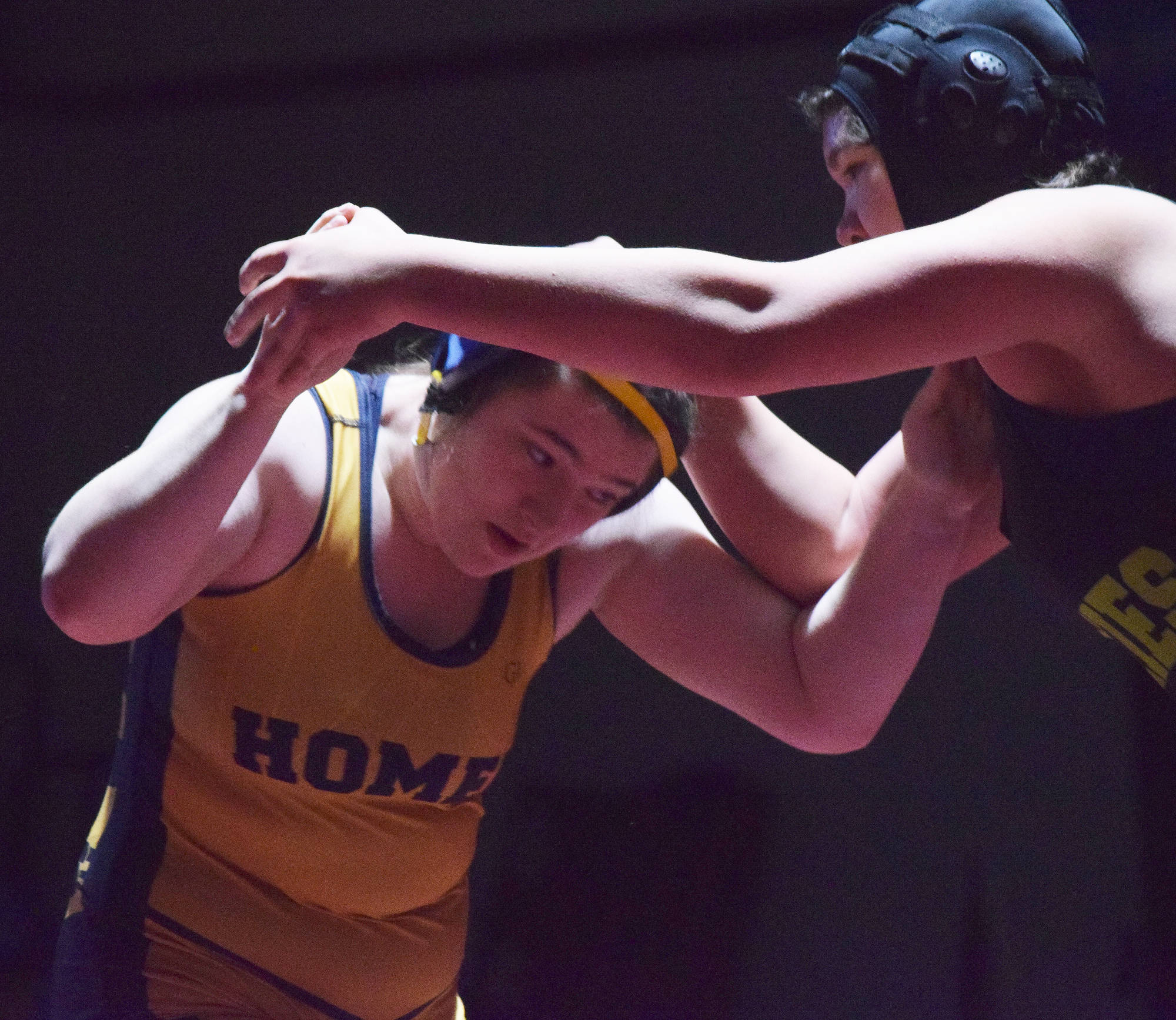 Homer’s Mariah Grimes (left) battles Redington’s Twyla Anderstrom for the girls 160-pound title Saturday at the Kachemak Conference wrestling tournament at Grace Christian High School in Anchorage. (Photo by Joey Klecka/Peninsula Clarion)