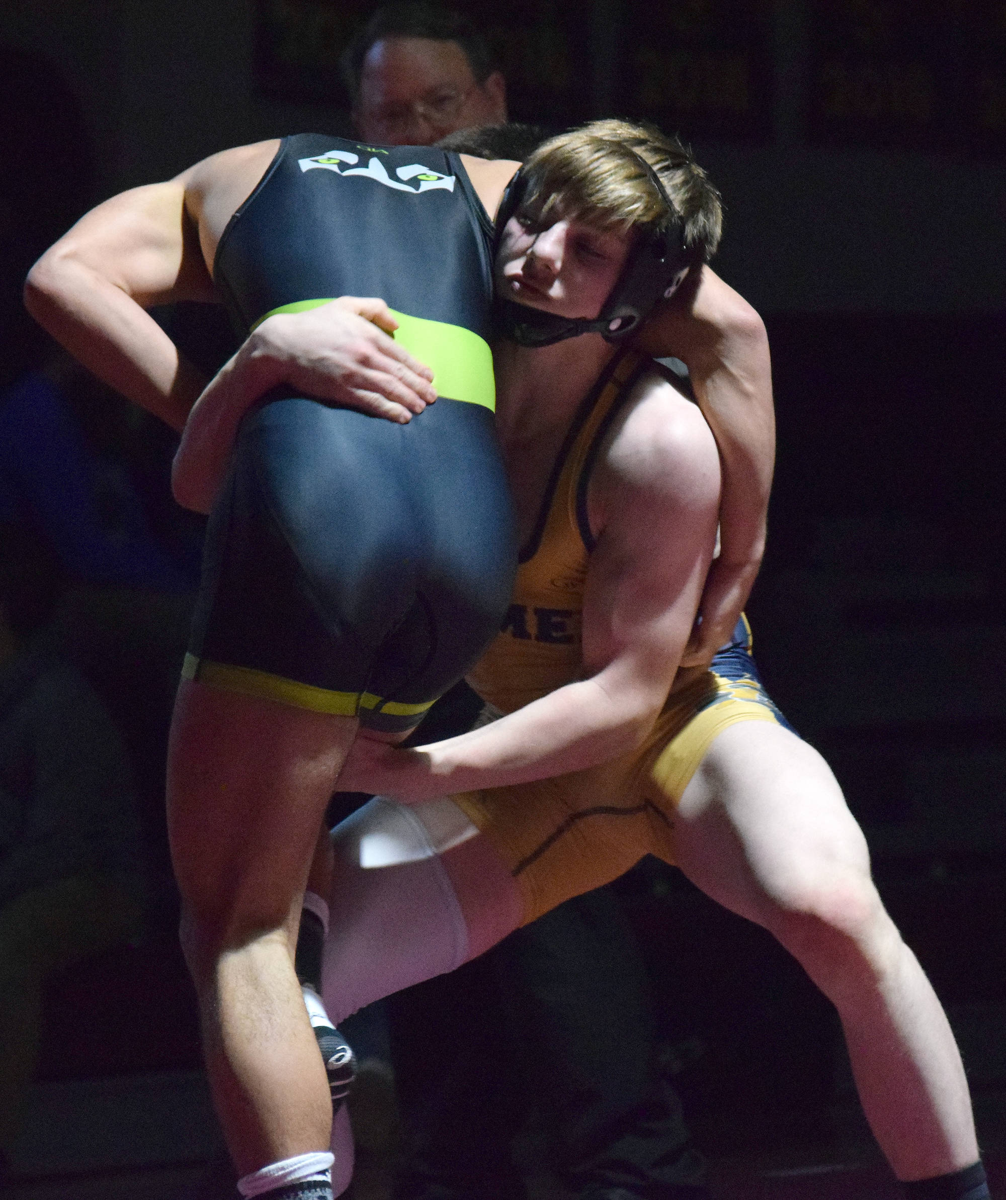 Homer’s Wayne Newman gains an advantage on Redington’s Gavin Metcalf Saturday in the 140-pound championship at the Kachemak Conference wrestling tournament at Grace Christian High School in Anchorage. (Photo by Joey Klecka/Peninsula Clarion)