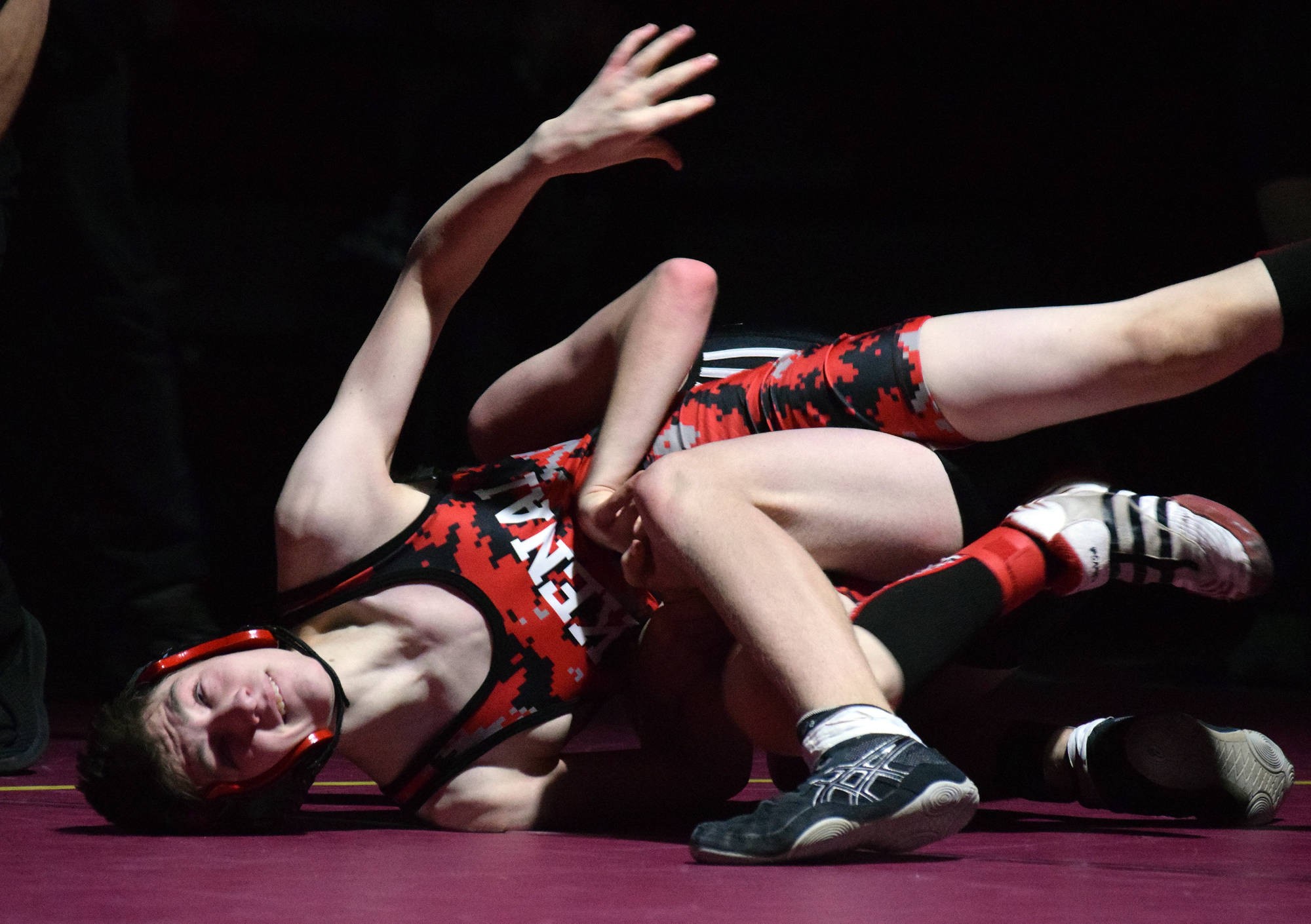 Kenai Central wrestler Talon Whicker fights against Nikiski’s Griffin Gray Saturday at the Kachemak Conference wrestling tournament at Grace Christian High School in Anchorage. (Photo by Joey Klecka/Peninsula Clarion)