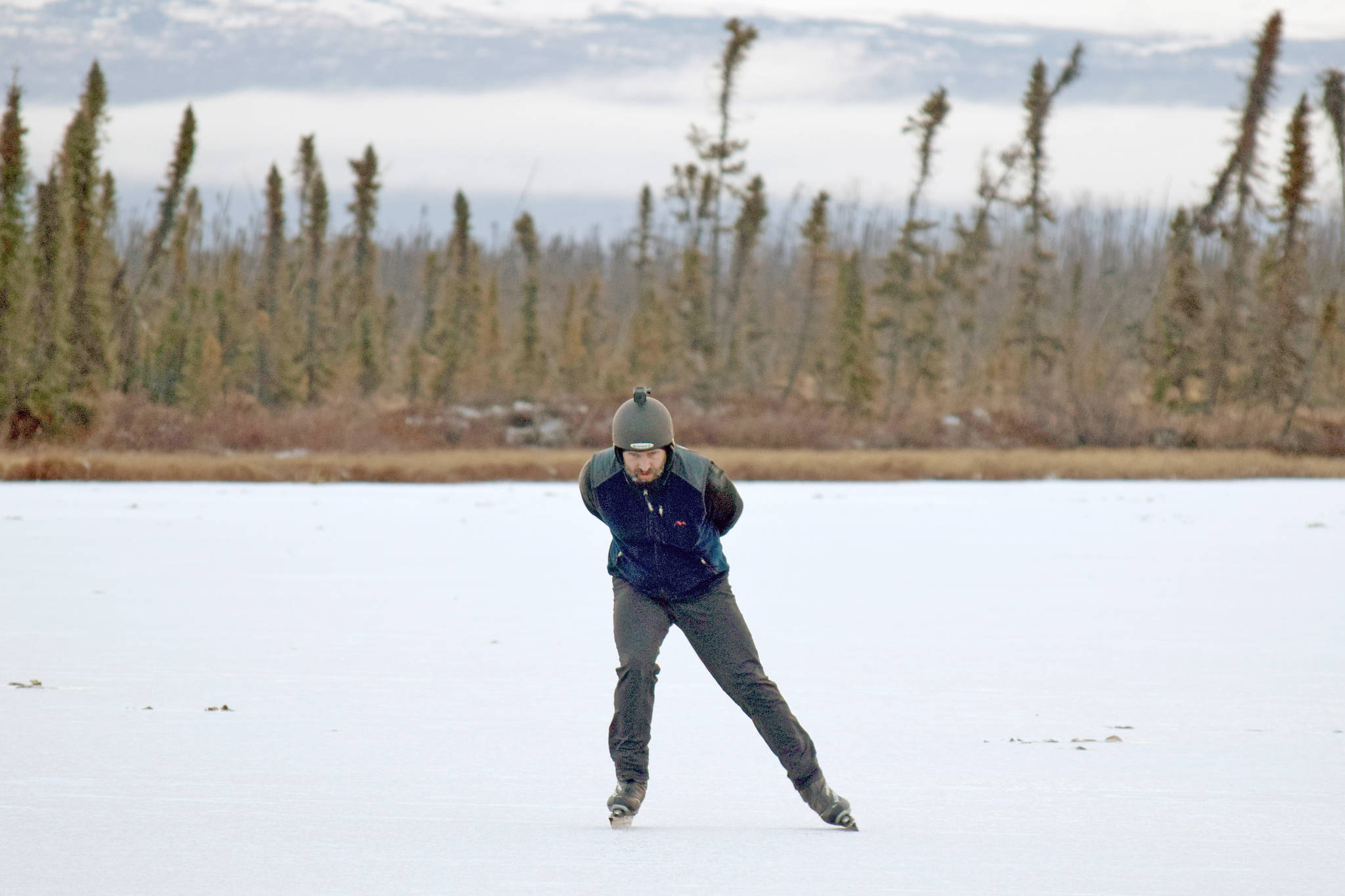 Trevor Davis skates on Bottenintnin Lake on Monday, Dec. 10, 2018. (Photo by Jeff Helminiak/Peninsula Clarion)