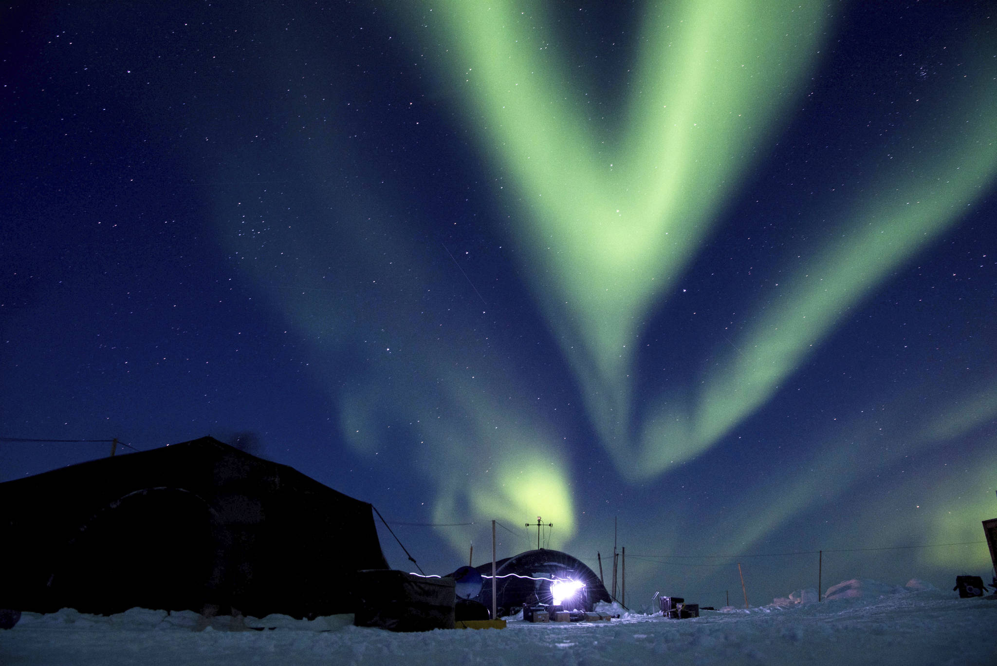 In this March 9 file photo provided by the U.S. Navy, the aurora borealis displays above Ice Camp Skate in the Beaufort Sea during Ice Exercise (ICEX) 2018. Scientists are seeing surprising melting in Earth’s polar regions at times they don’t expect, like winter, and in places they don’t expect, like eastern Antarctica. (MC 2nd Class Micheal H. Lee/U.S. Navy via AP, File)