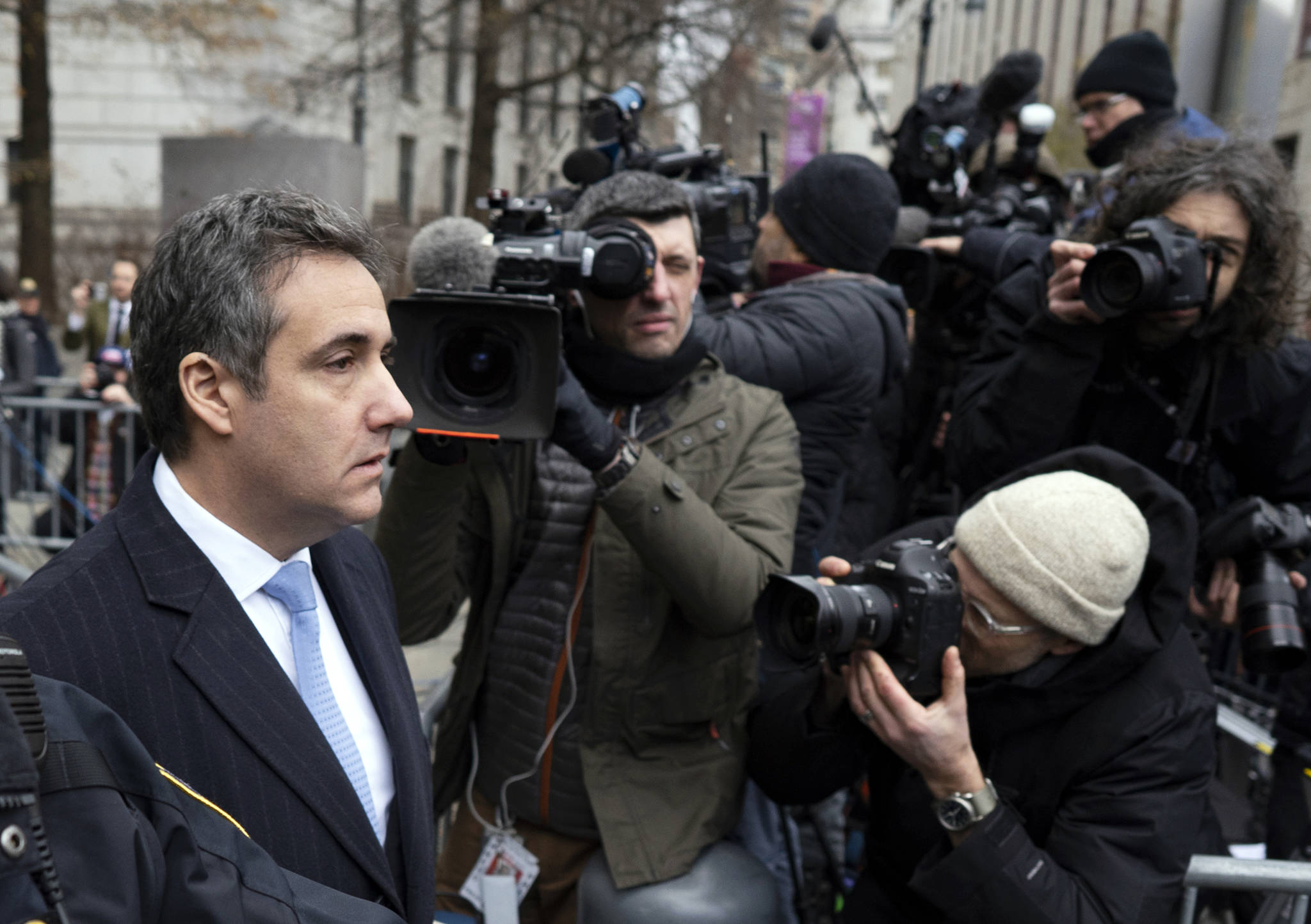 Michael Cohen, left, President Donald Trump’s former lawyer, leaves federal court after his sentencing in New York, Wednesday, Dec. 12, 2018. Cohen was sentenced Wednesday to three years in prison for an array of crimes that included arranging the payment of hush money to two women that he says was done at the direction of Trump. (AP Photo/Craig Ruttle)