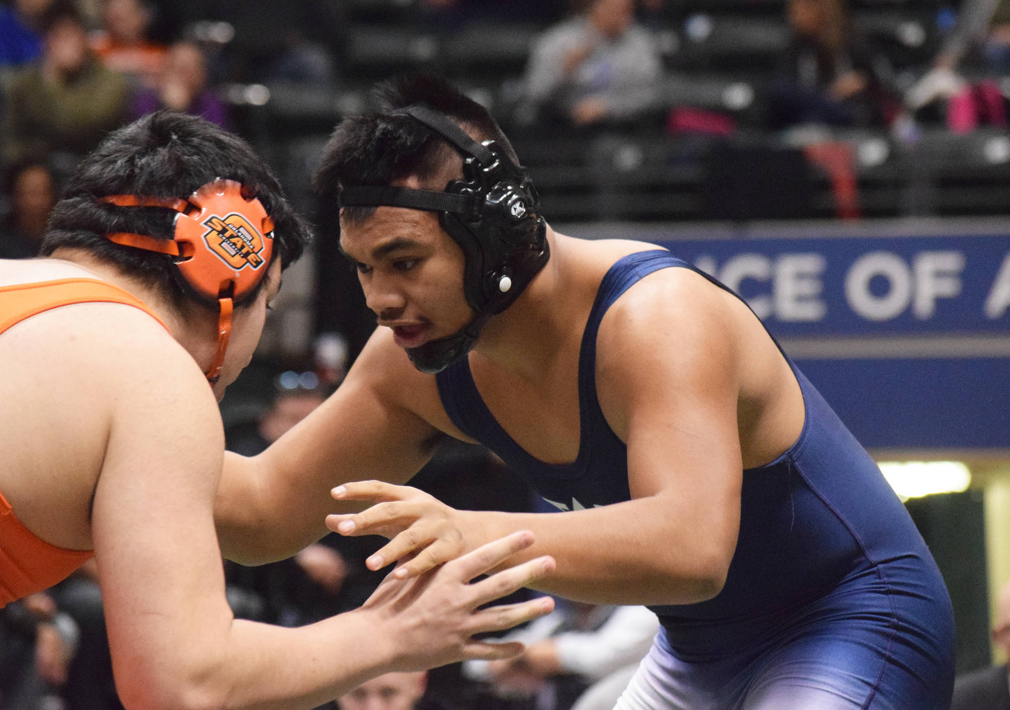 Soldotna senior Aaron Faletoi anticipates the moves of West Anchorage’s Kelton Mock in the 215-pound final Saturday night at the Div. I state wrestling championships at the Alaska Airlines Center in Anchorage. (Photo by Joey Klecka/Peninsula Clarion)