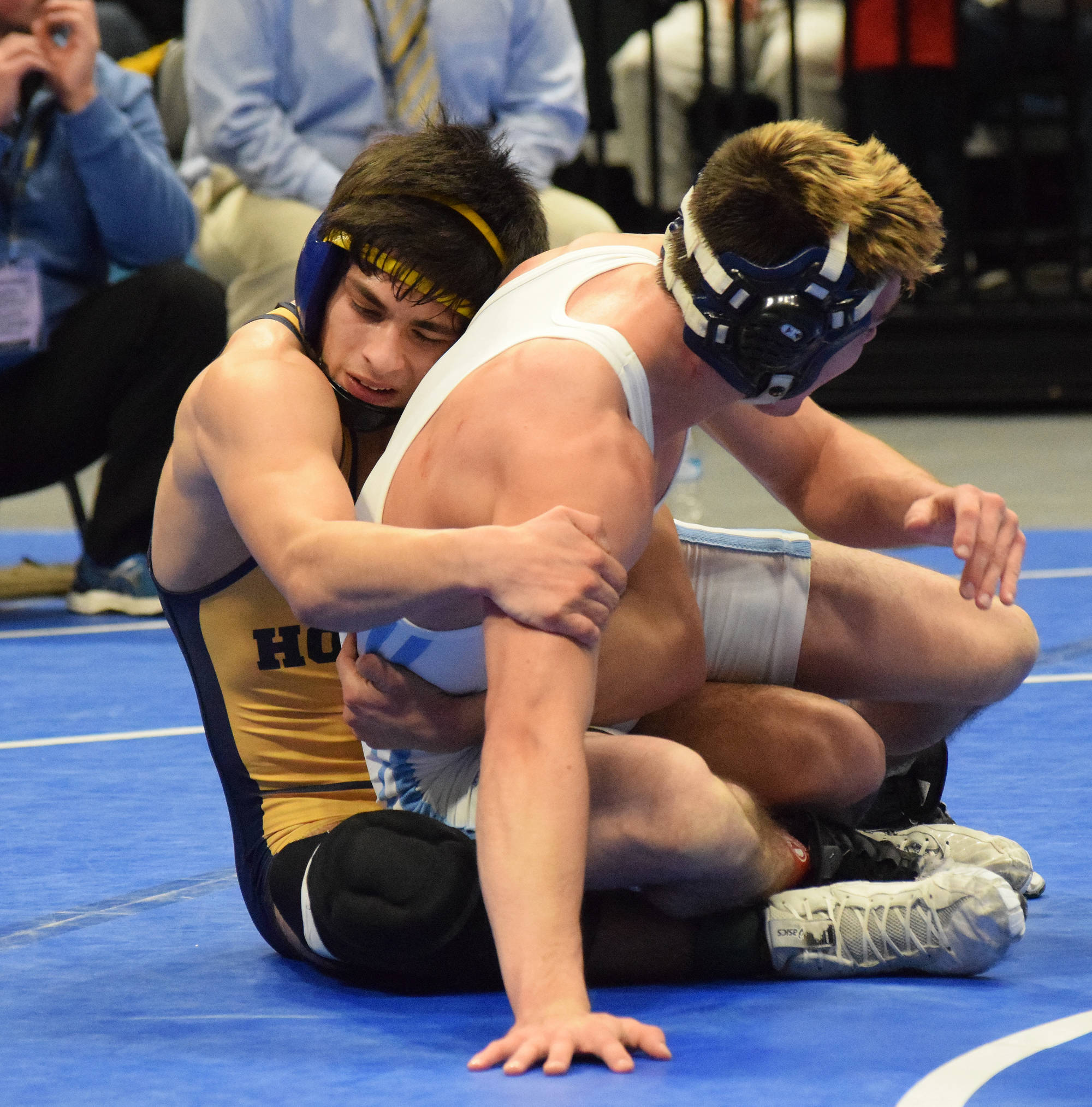 Homer senior Luciano Fasulo works on Dillingham’s Chris Williams in the 135-pound final Saturday night at the Div. II state wrestling championships at the Alaska Airlines Center in Anchorage. (Photo by Joey Klecka/Peninsula Clarion)