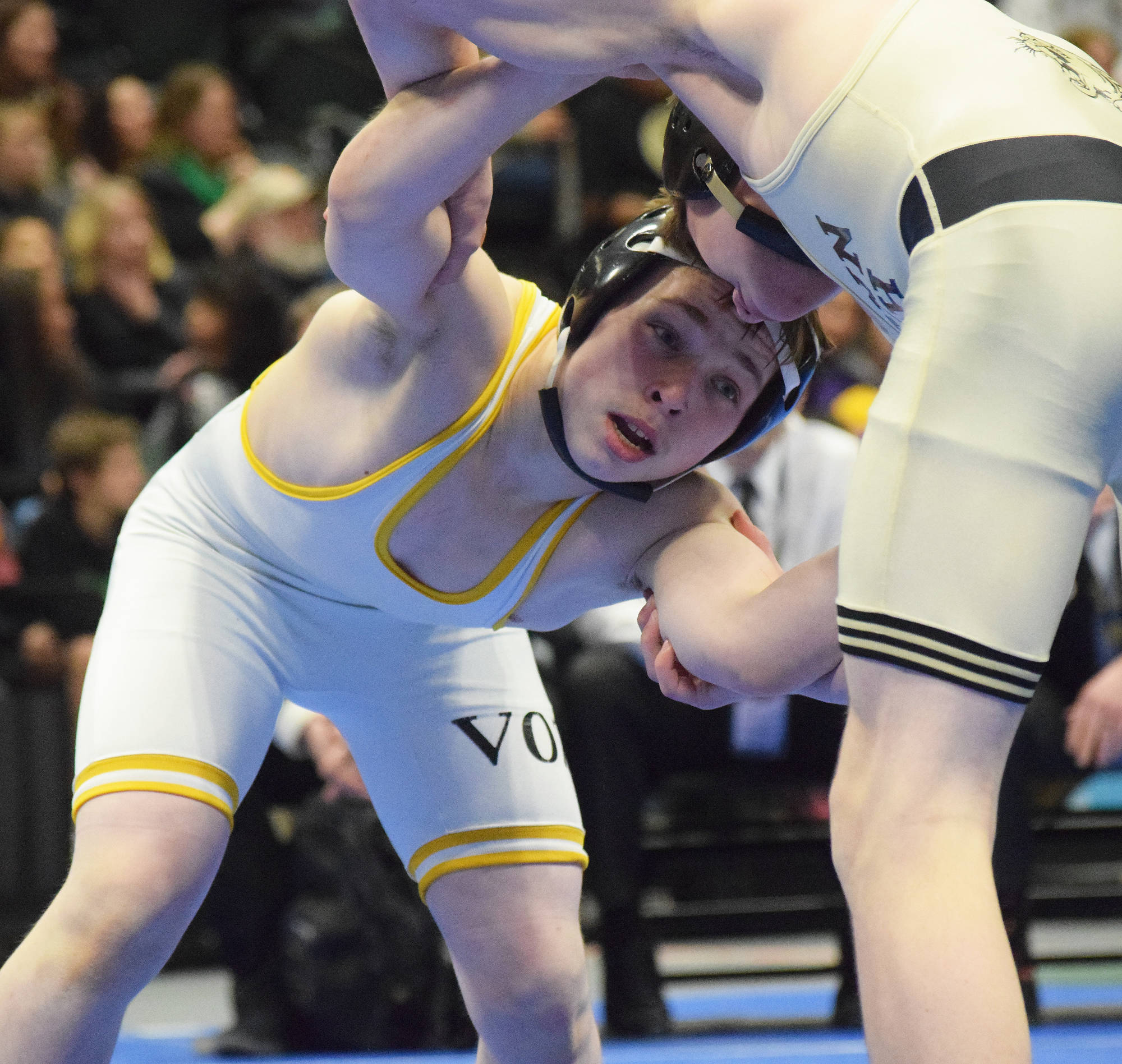 Voznesenka’s Max Kusnetsov looks for a move to make against Glennallen’s Alex Buck in the 119-pound final Saturday night at the Div. II state wrestling championships at the Alaska Airlines Center in Anchorage. (Photo by Joey Klecka/Peninsula Clarion)
