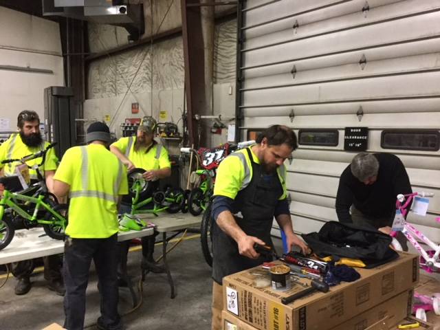 (From left to right) Alaska Waste workers Charlie Kuntz, Josue (Sway) Rivera-Cruz, Tim Lawrence, Steven Denicola, Dave Johnson. prepare bikes for donation to Love Inc. (Photo: Josue Rivera-Cruz/Alaska Waste)