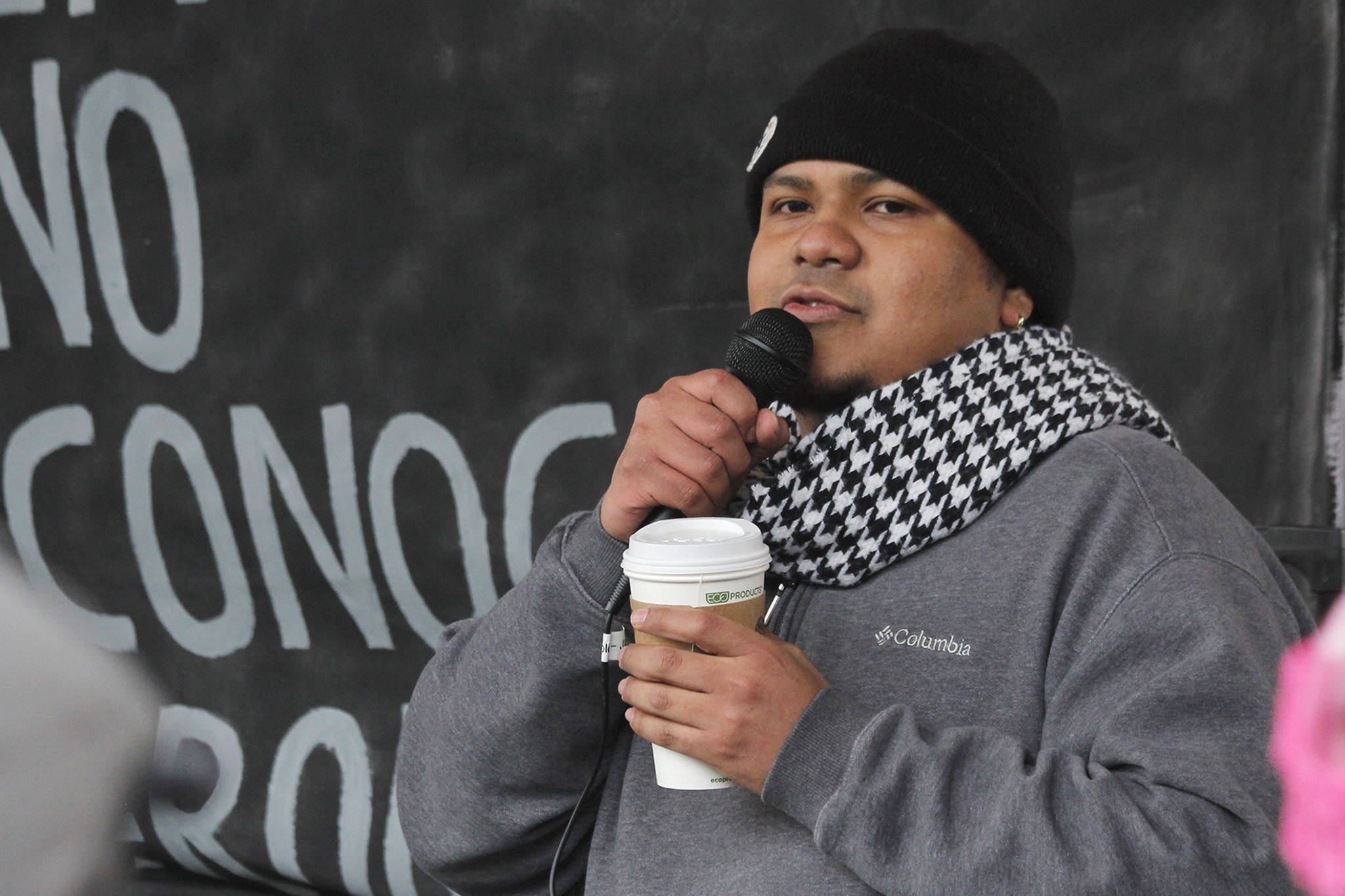 Manni Guillen, whose family moved to Juneau from Mexico when he was a baby, speaks at the Love Knows No Borders rally in Juneau on Saturday, Dec. 15, 2018. Guillen spoke about his experiences growing up in Juneau and working with the Border Angels nonprofit. (Alex McCarthy | Juneau Empire)