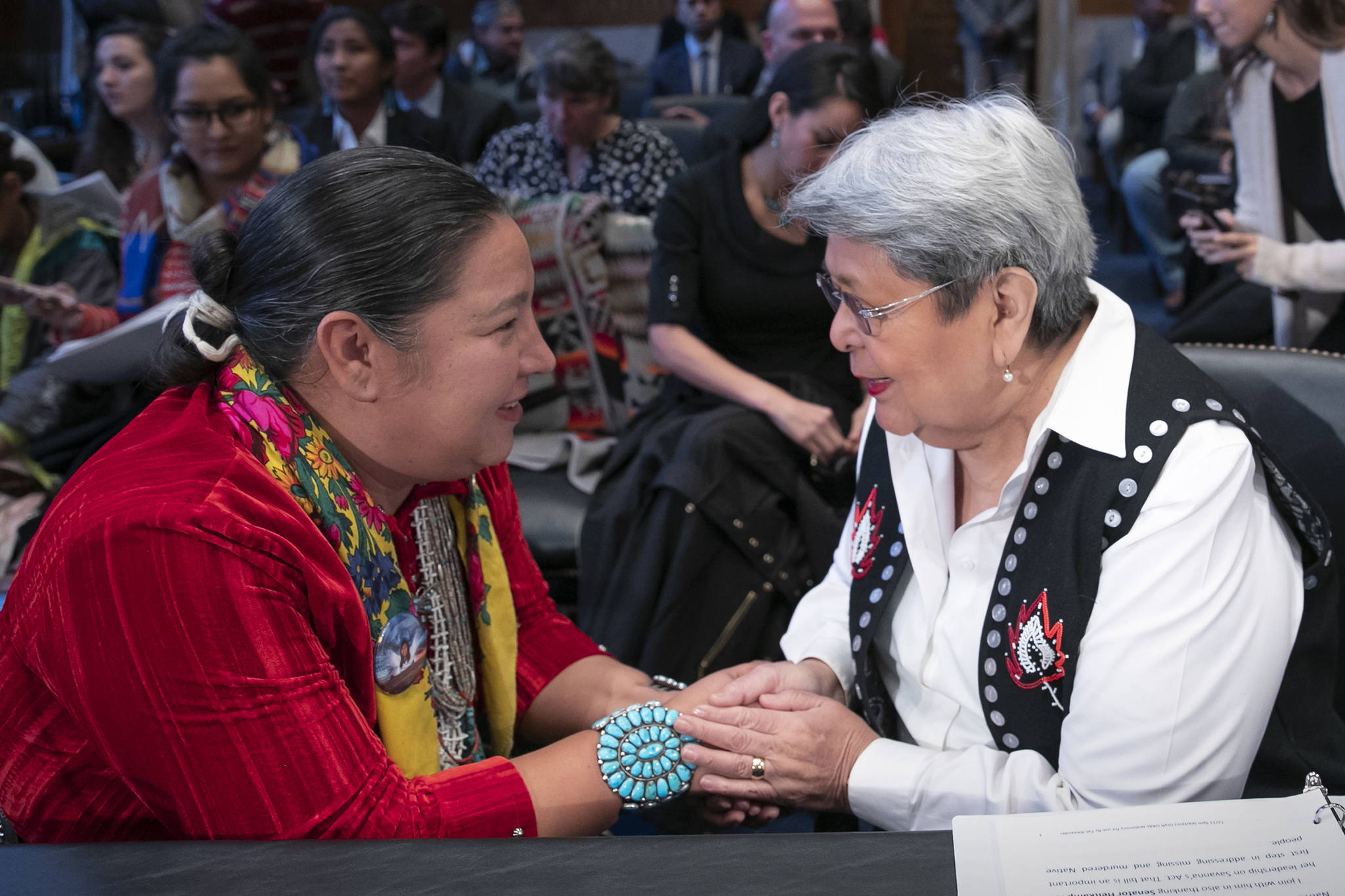 Amber Crotty from Window Rock, Ariz., left, a delegate of the Navajo Nation Council, and Patricia Alexander of the Tlingit and Haida Indian Tribes of Alaska, right, exchange words of encouragement to each other before testifying as the Senate Committee on Indian Affairs holds a hearing to examine concerns about investigations into the deaths and disappearance of Native American women, on Capitol Hill in Washington, Wednesday, Dec. 12, 2018. (AP Photo | J. Scott Applewhite)