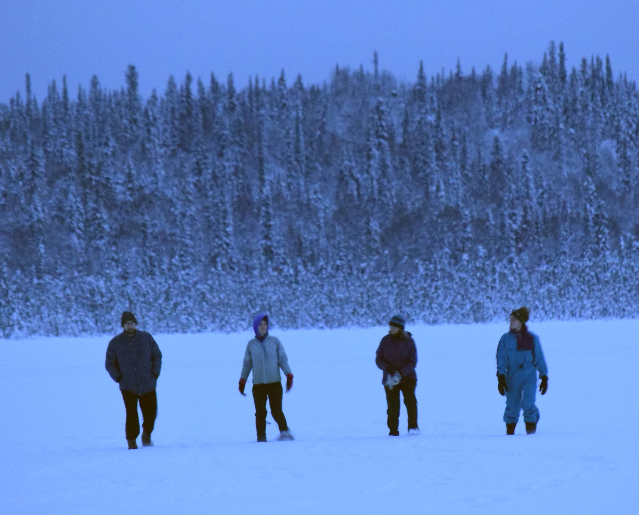 John Loranger, Ruby Glaser, Linda Loranger and Alice Main snowshoe on Headquarters Lake during a winter solstice event at the Kenai National Wildlife Refuge on Friday. (Photo by Jeff Helminiak/Peninsula Clarion)