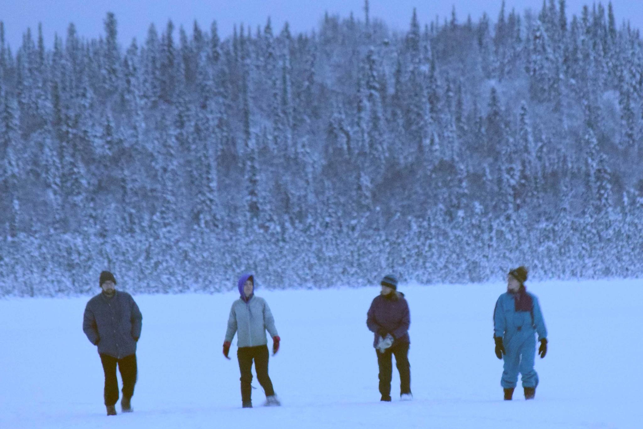 John Loranger, Ruby Glaser, Linda Loranger and Alice Main snowshoe on Headquarters Lake during a winter solstice event at the Kenai National Wildlife Refuge on Friday, Dec. 21, 2018. (Photo by Jeff Helminiak/Peninsula Clarion)